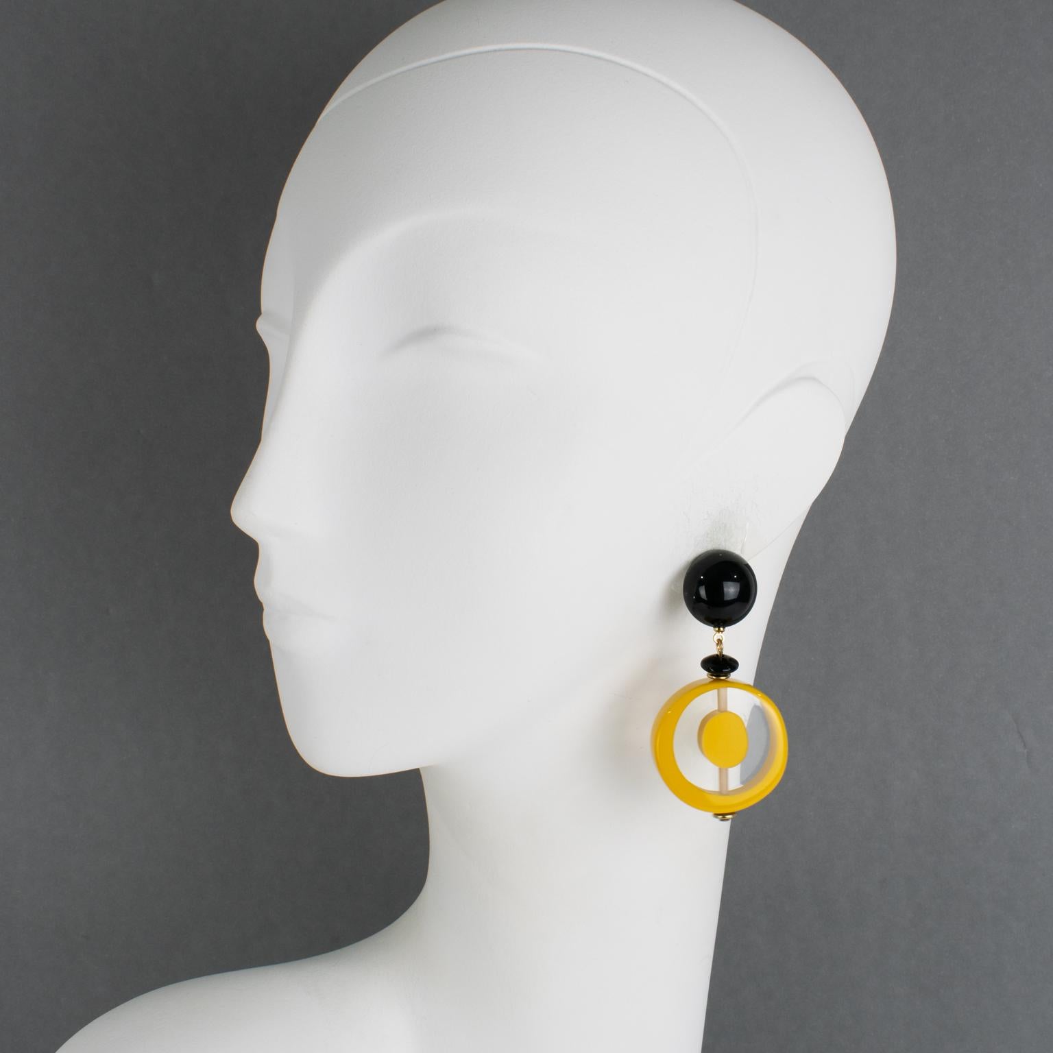 These lovely Angela Caputi pierced earrings, made in Italy, feature a 1970s revival-inspired design with geometric resin pebbles. Each rounded pebble bead is carved and slightly domed. The color scheme is playing on a yellow pineapple tone, either