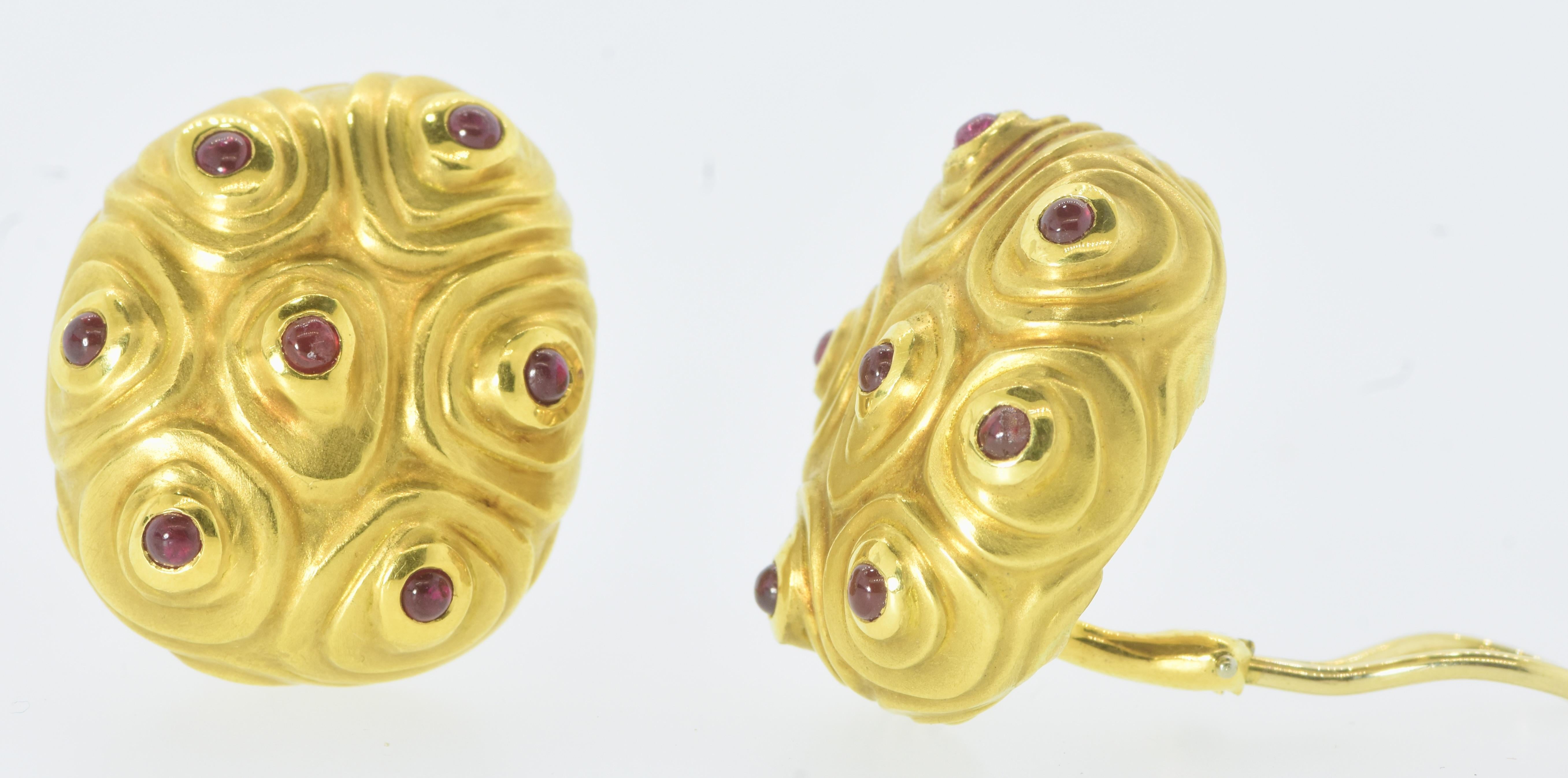 18K yellow gold vintage earrings each with 7 small cabochon circular natural rubies of Burma color, Angela Cummings.  This is the larger model - rarely found.

These are cushion shaped bulbous ear clips weighing exactly 38.5 grams. Their length is