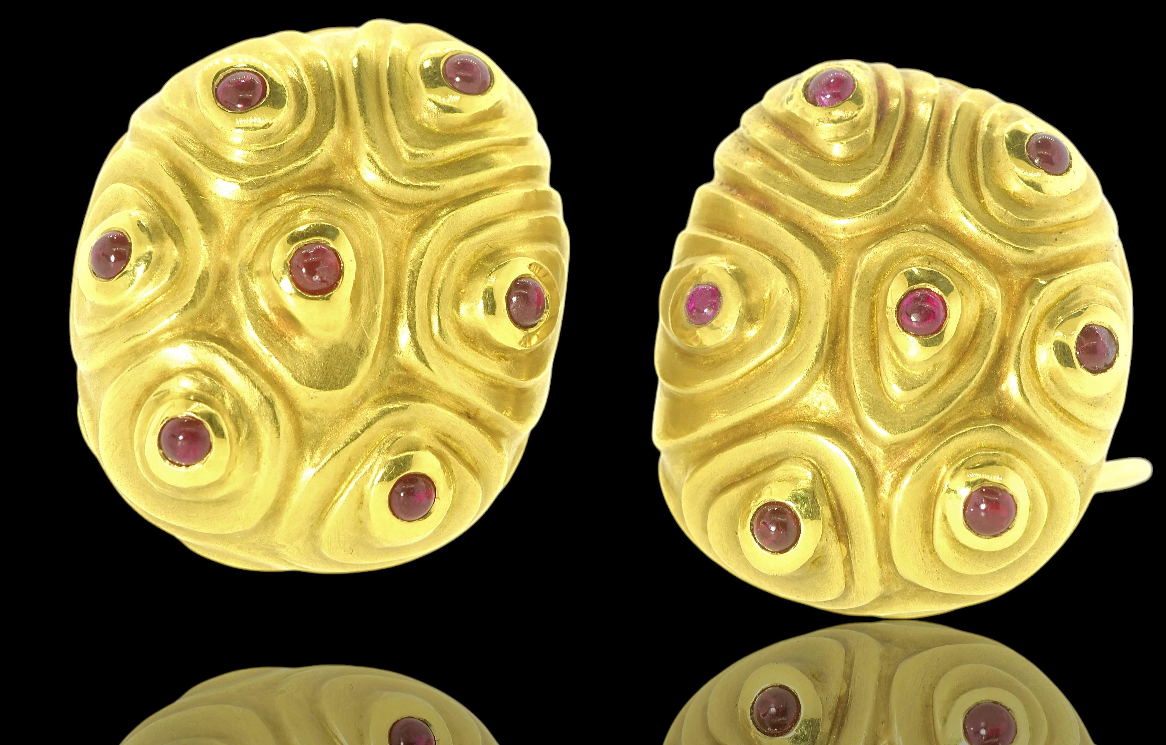 18K yellow gold vintage large and robust earrings each with 7 small cabochon circular natural rubies of Burma color by Angela Cummings.

These are cushion shaped bulbous ear clips weighing exactly 38.5 grams. Their length is just under 1.25 inches