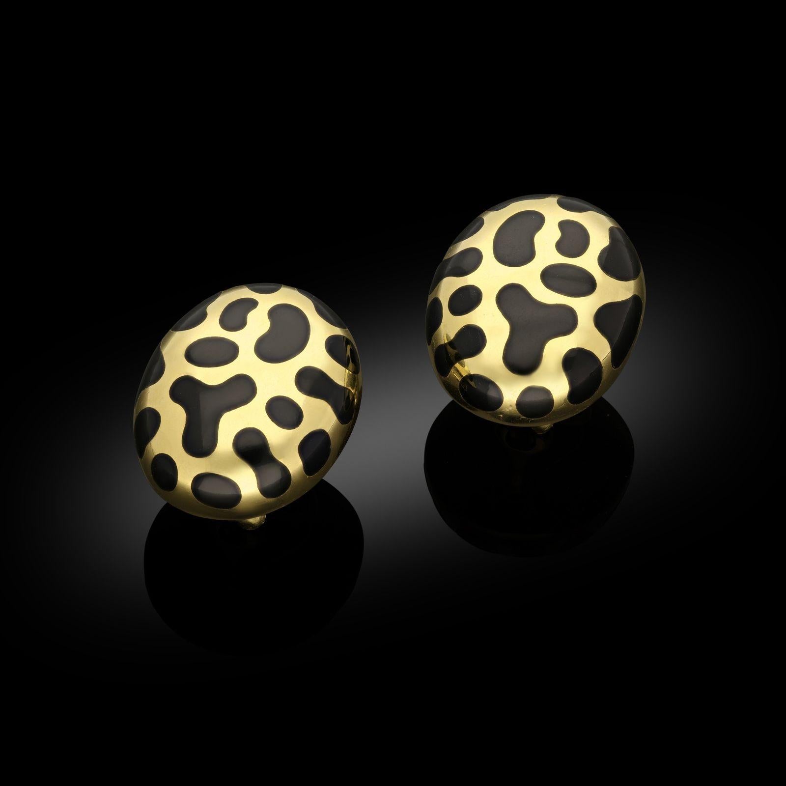 A bold and striking pair of gold and black jade earrings by Angela Cummings c.1980s, the large oval domed earrings in highly polished 18ct yellow gold, each inlaid with sixteen irregular shaped pieces of carved and polished black jade, with post and