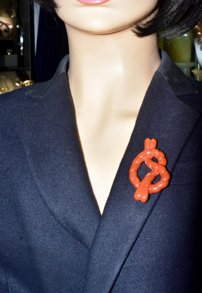 Angela Cummings 18K yellow gold and orange-red agate knot.  Angela Cummings was a major designer for Tiffany & Co., and also designed jewelry for her own line.  This large brooch is an iconic Angela Cummings piece, it is easy to wear, and