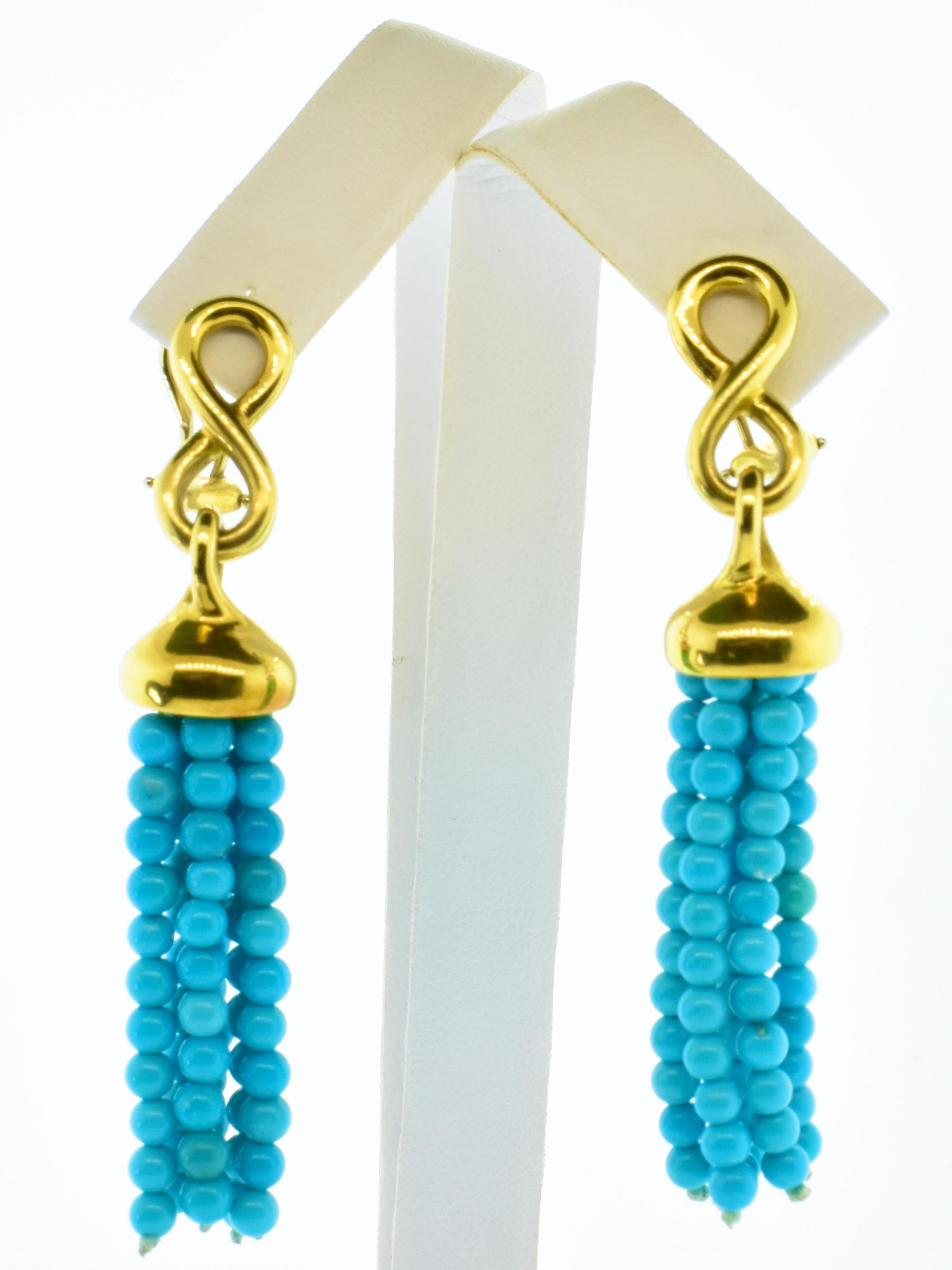 Angela Cummings 18K and natural turquoise tassel drop earrings. These earrings are by a top American designer, well. made with fine materials.  They are long and unusual and not a commercial grade piece of jewelry seen so prevalent today. 
 The tops