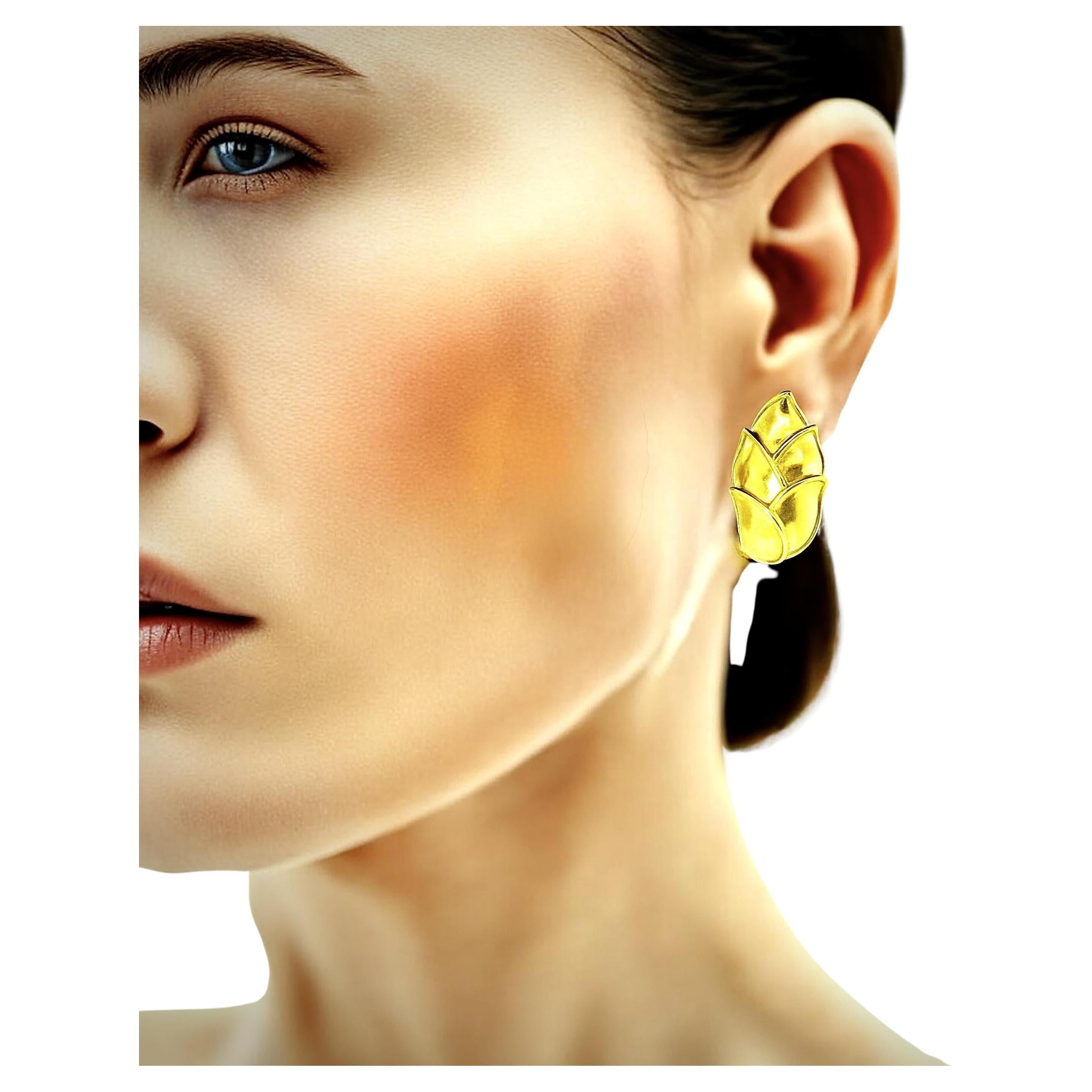 Angela Cummings, a major designer for Tiffany 
Co., has designed these very wearable earrings in 18K yellow gold. 
 These earrings are 1.25 inches long and .75 inches wide.  Each earring is signed Cummings with the copyright date of 1989. 