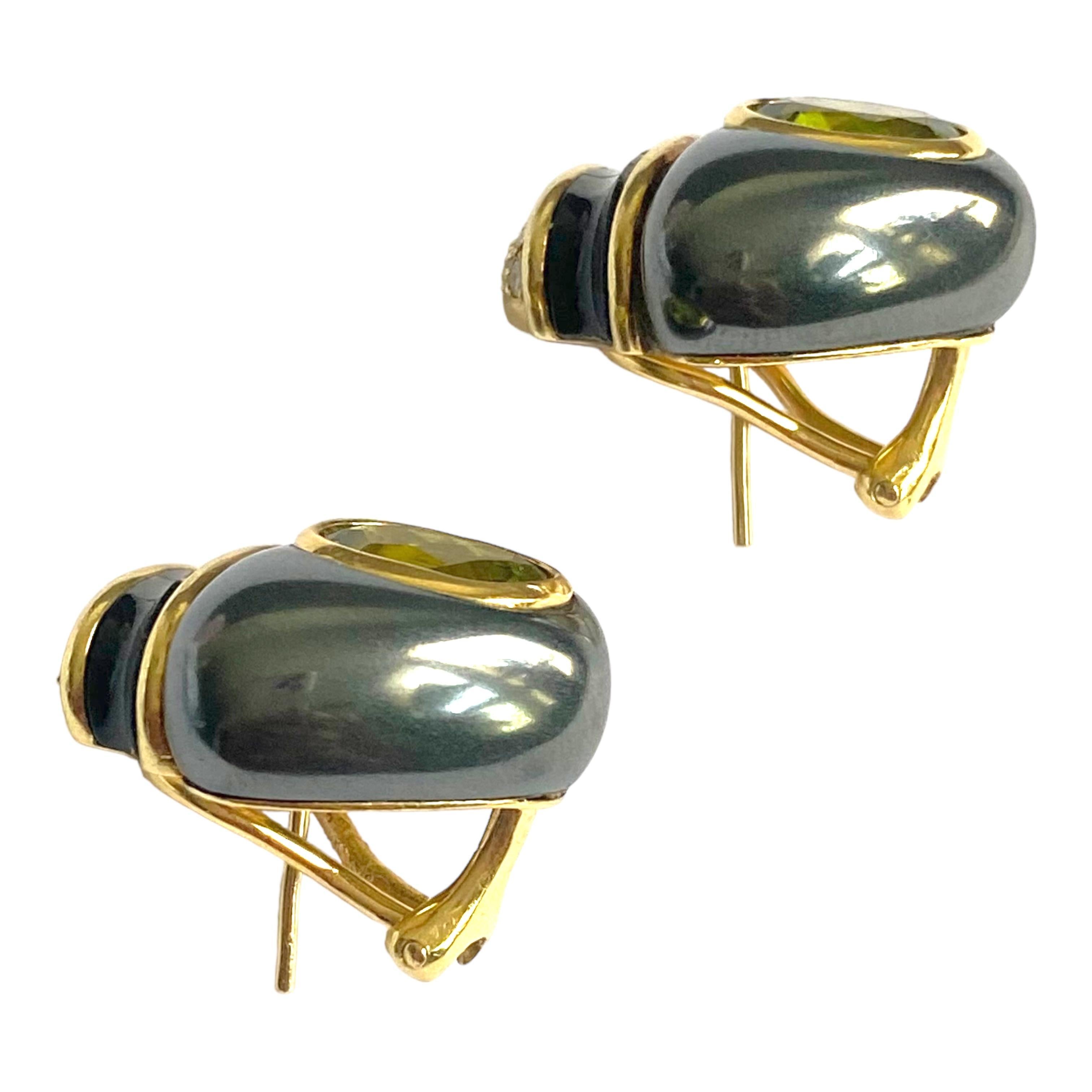 Crafted in 18K yellow gold, each earring features an oval bezel set peridot imbedded in hematite, topped with inlay onyx and mother-of-pearl and a pave diamond cap.
Omega and post backings for extra security. Bright polish finish.
 Measurements 