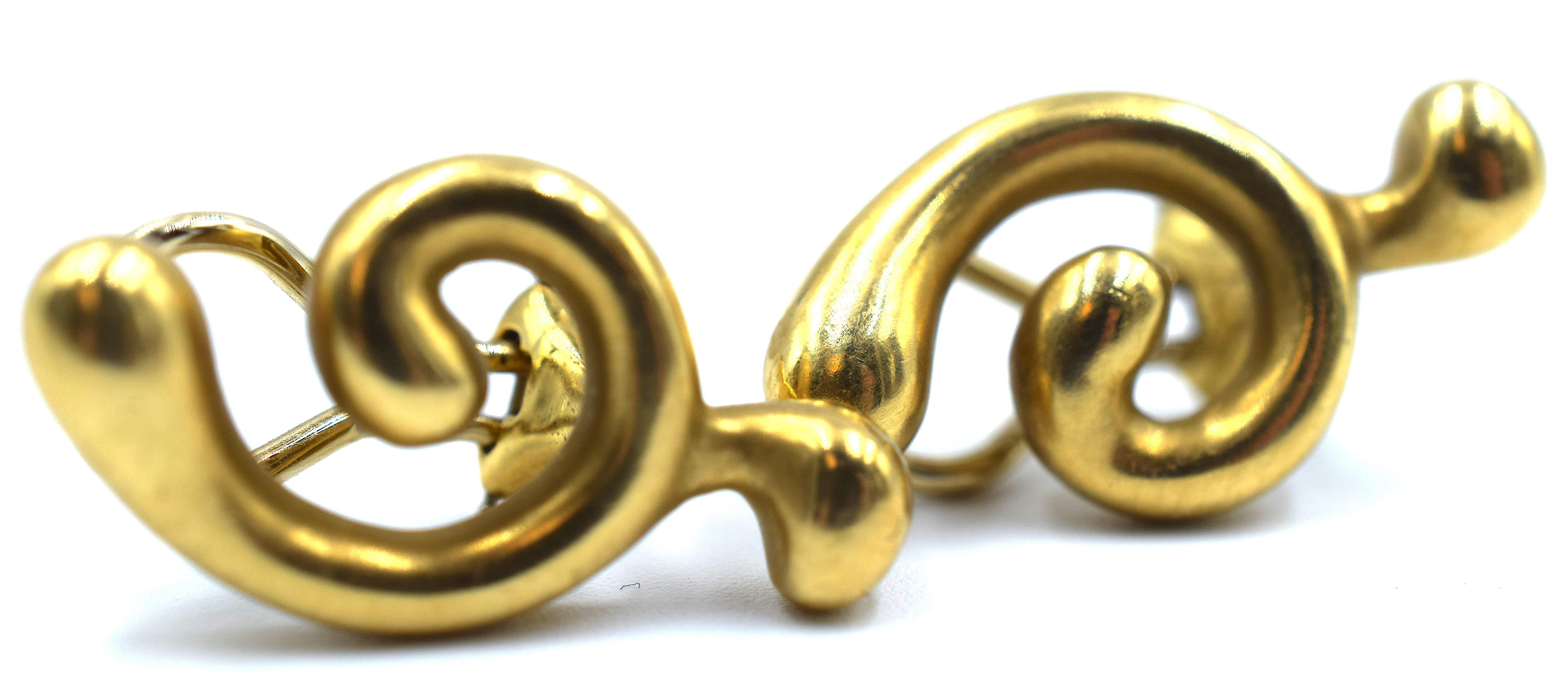 Amazing pair of vintage earrings from famed designer Angela Cummings. These earrings are crafted in 18k yellow gold and show a satin finish.  This contemporary design shows a swirling pattern that is great for every day wear. The pair is hallmarked