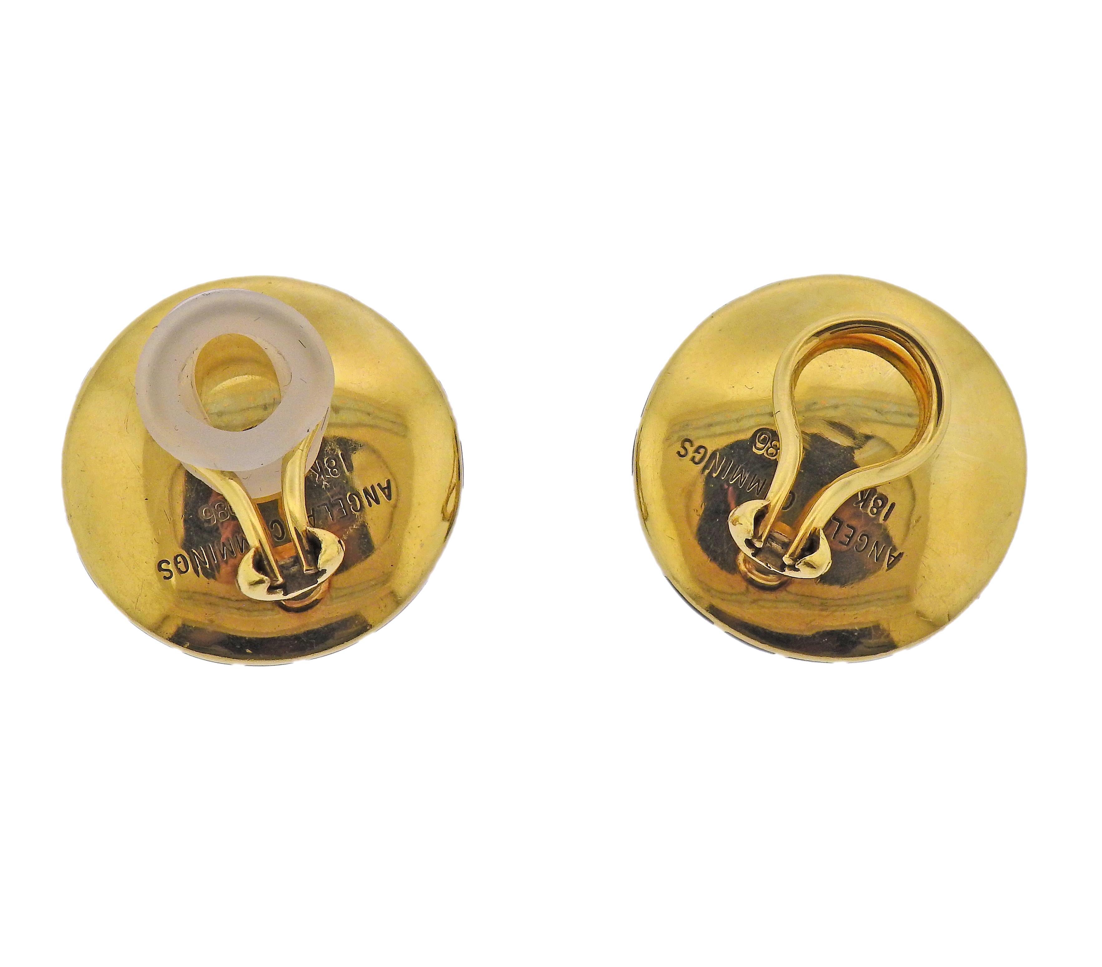 Pair of 18k gold round earrings by Angela Cummings, crafted in 1986, with inlayed black jade. Earrings are 25mm in diameter (1