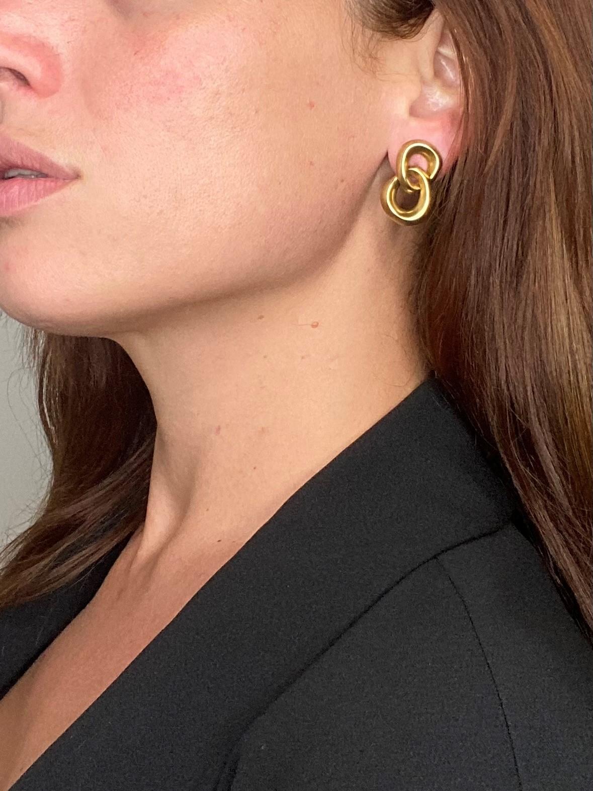 Pair of earrings designed by Angela Cummings.

Double circled pieces, created by Cummings at her New York studio, back in the 1986. This pair of earrings has been crafted in solid yellow gold of 18 karats. The surfaces are treated with light frosted