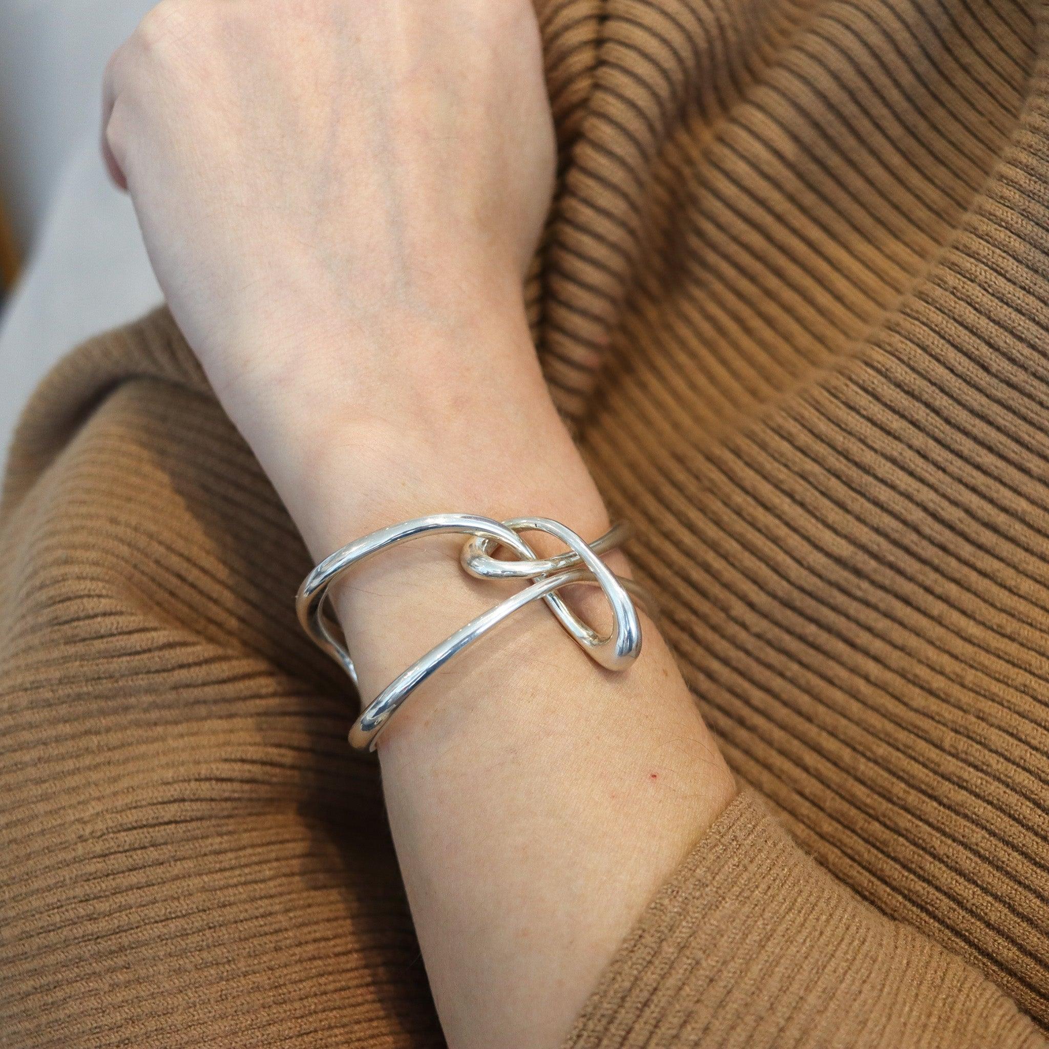 Twisted cuff-bracelet designed by Angela Cummings.

This is a beautiful sculptural cuff-bracelet created by Angela Cummings at her own silversmith studio in New York City, back in the 1997. This cuff has been designed with modernist patterns as a