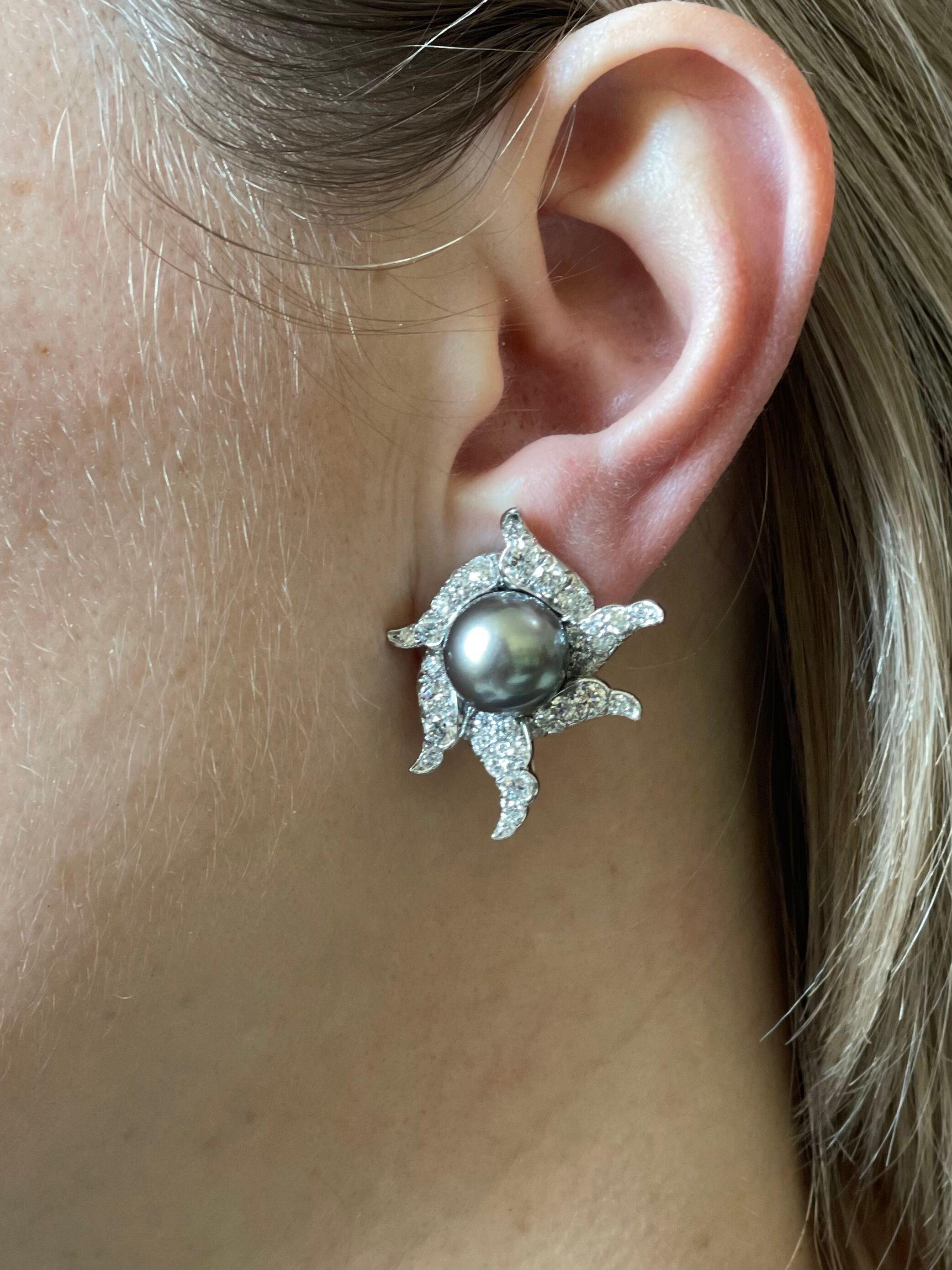 Pair of 18k gold and platinum cocktail earrings by Angela Cummings for Assael, set with approx. 2.20ctw G/VS diamonds and 11.5mm Tahitian South Sea pearls in the center. Earrings measure 1.25