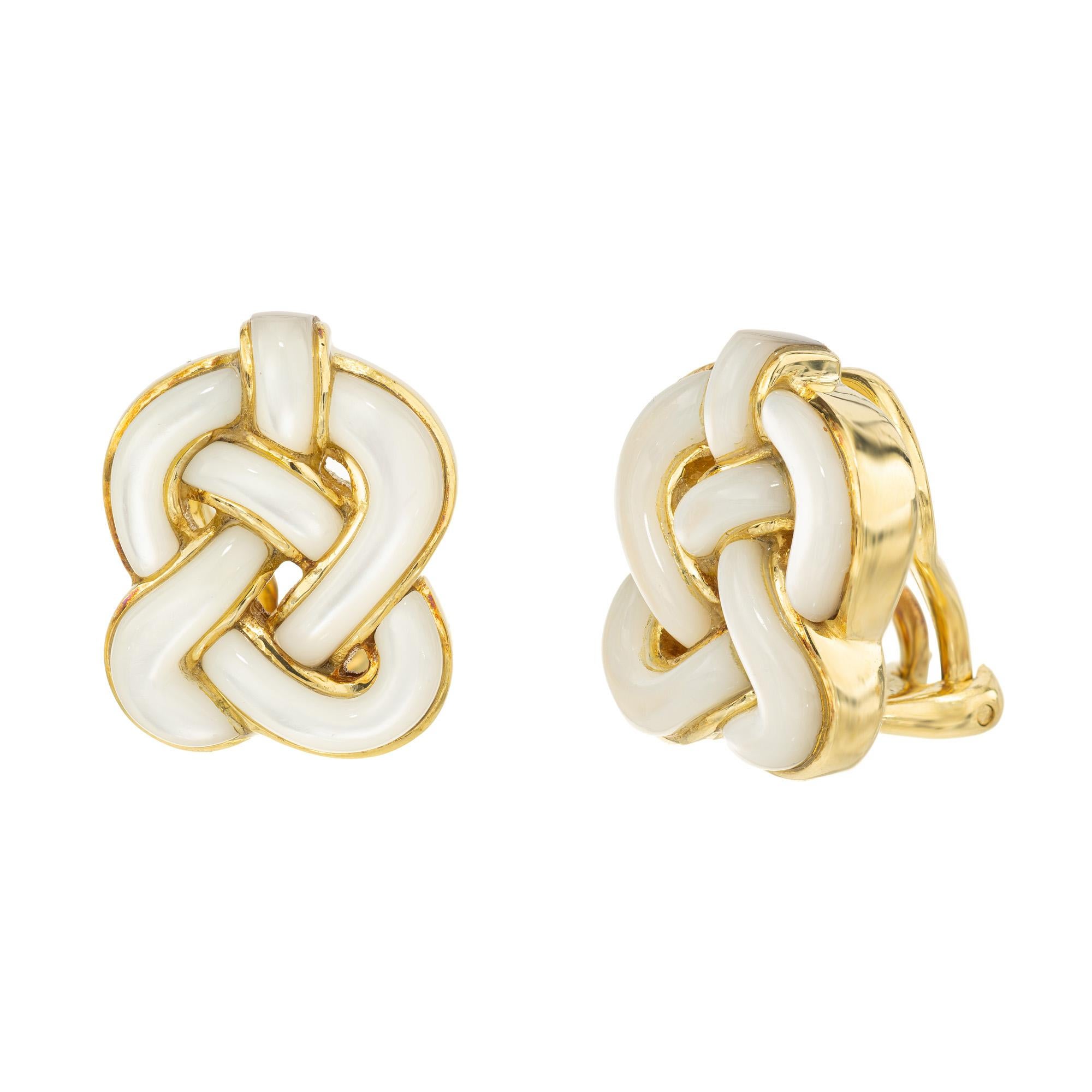 Embrace the allure of ancient design with the Angela Cummings carved Mother of Pearl gold Celtic knot clip post earrings. Each earring is a masterful symphony of carved mother of pearl delicately intertwined with 18k yellow gold, forming an