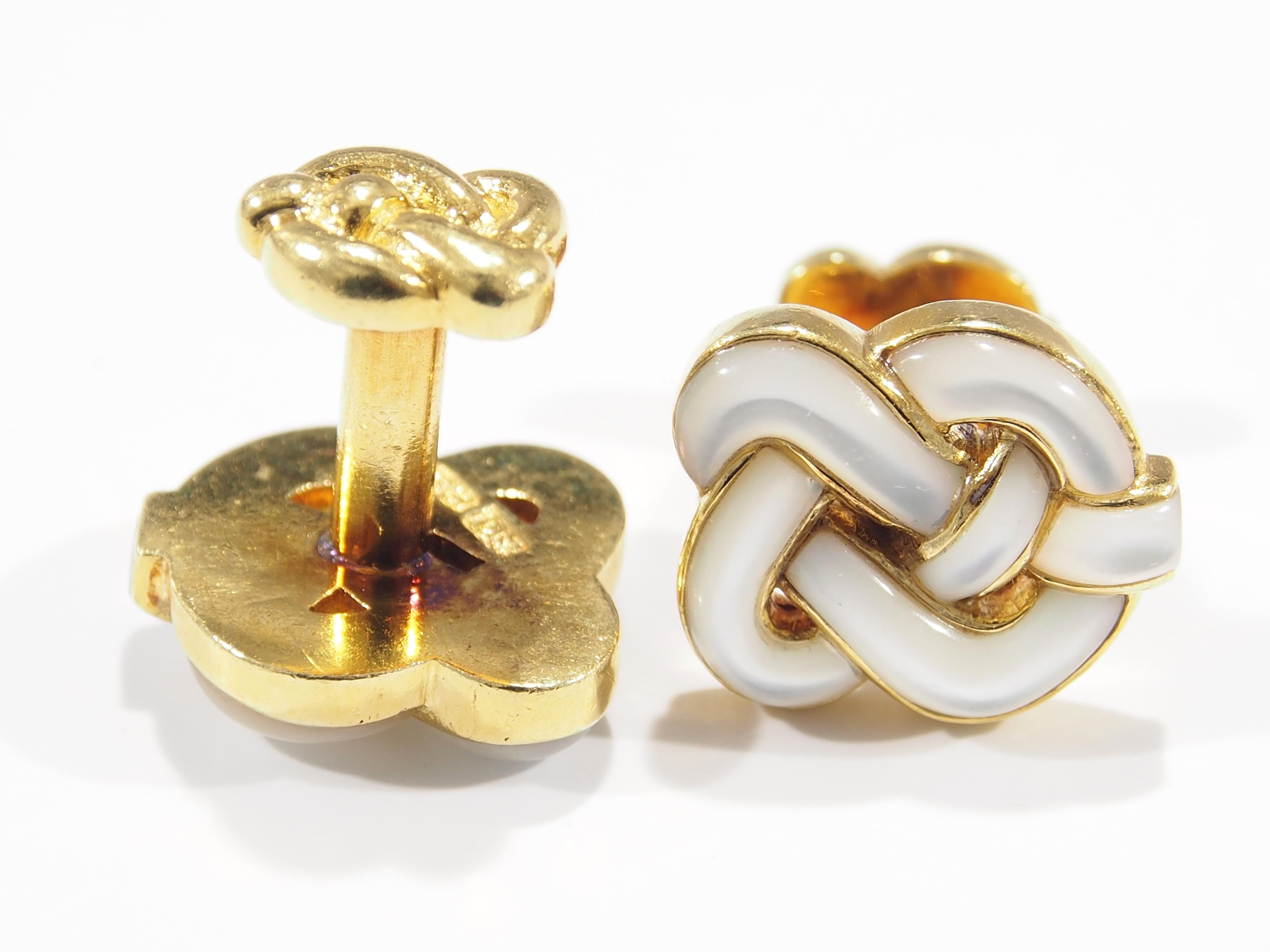 These are 18K Yellow Gold Cuff links designed by Angela Cumming with stunning  Mother of Pearl detail. The Mother of Pearl is  fashioned in a stunning detailed Nautical Knot Motif. The Cuff links are 3/4 inch in length, 5/8 inch in width, are