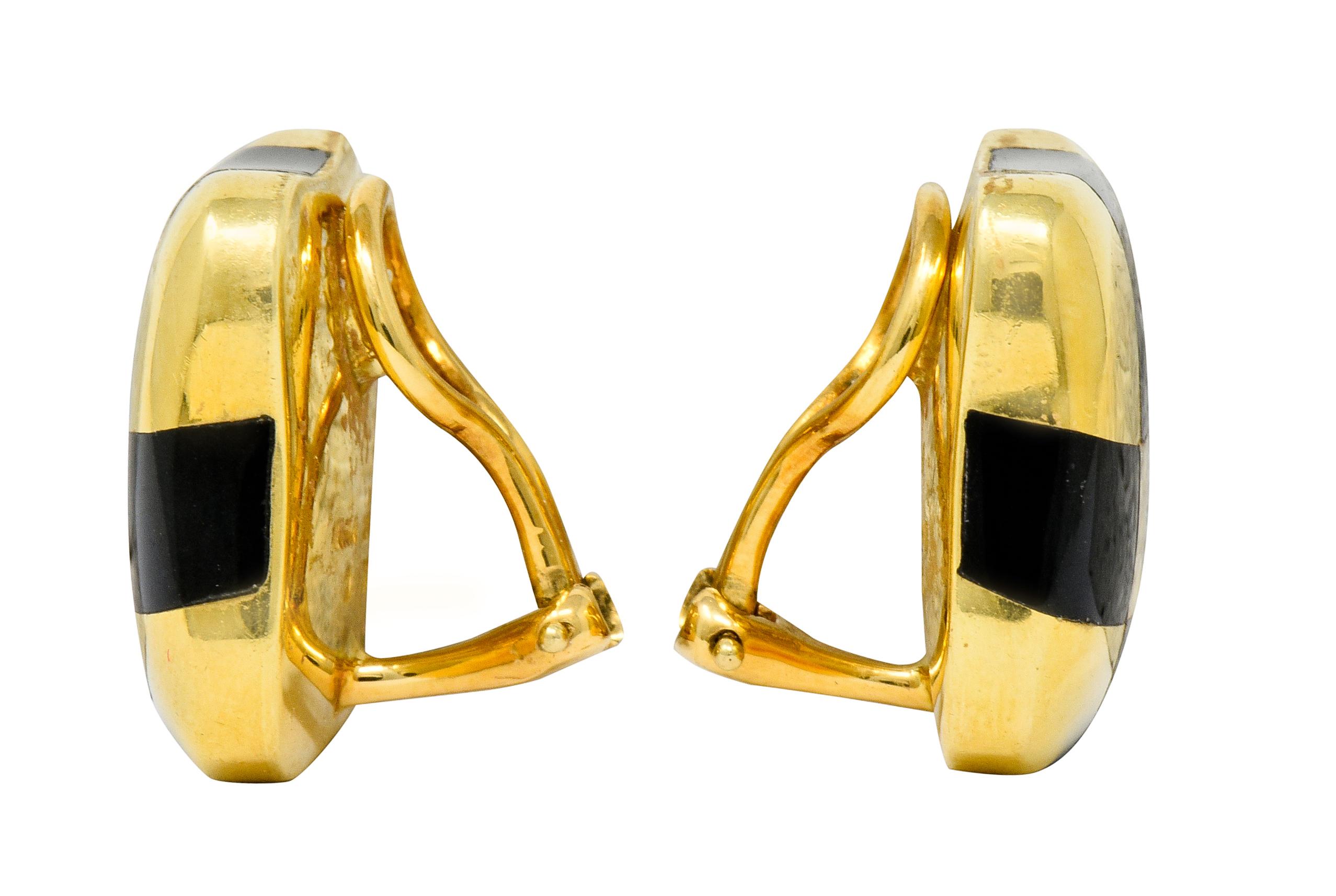 Cushion shaped ear-clip earrings with an organic form

Designed with a stylized checkerboard motif of polished gold alternating with glossed black enamel; exhibiting no loss

Completed by hinged omega backs

Fully signed Angela Cummings and stamped