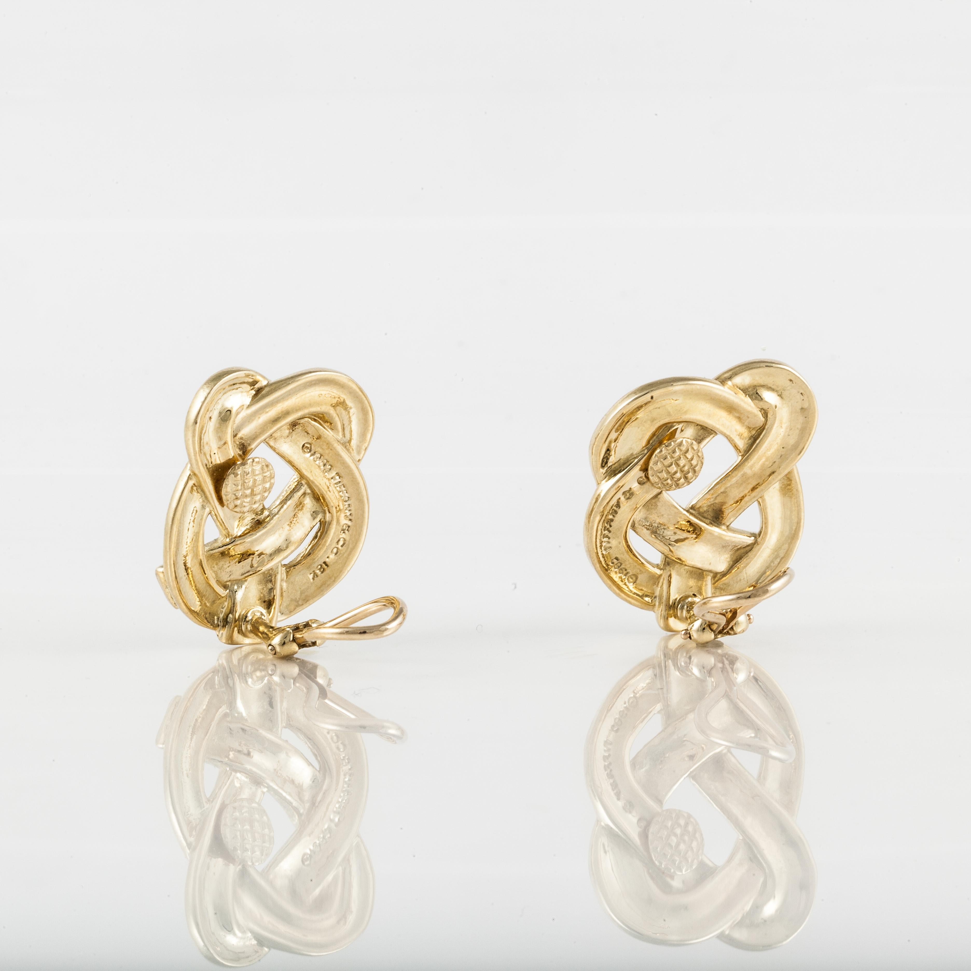 Pair of Angela Cummings for Tiffany & Co. earrings are crafted in 18K yellow gold with a pretzel twist design.  Dated 1982.  They measure 1 inch long and 7/8 inches wide.  Clip style.