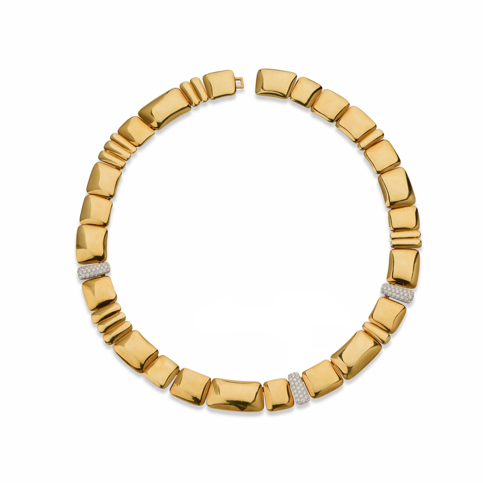 Created in 1980, this 18K gold and diamond necklace was designed by Angela Cummings and made by Tiffany & Co. It is designed as a series of cushion-shape slightly-bombé gold links of varying dimensions, highlighted by three pavé-set diamond bars.
