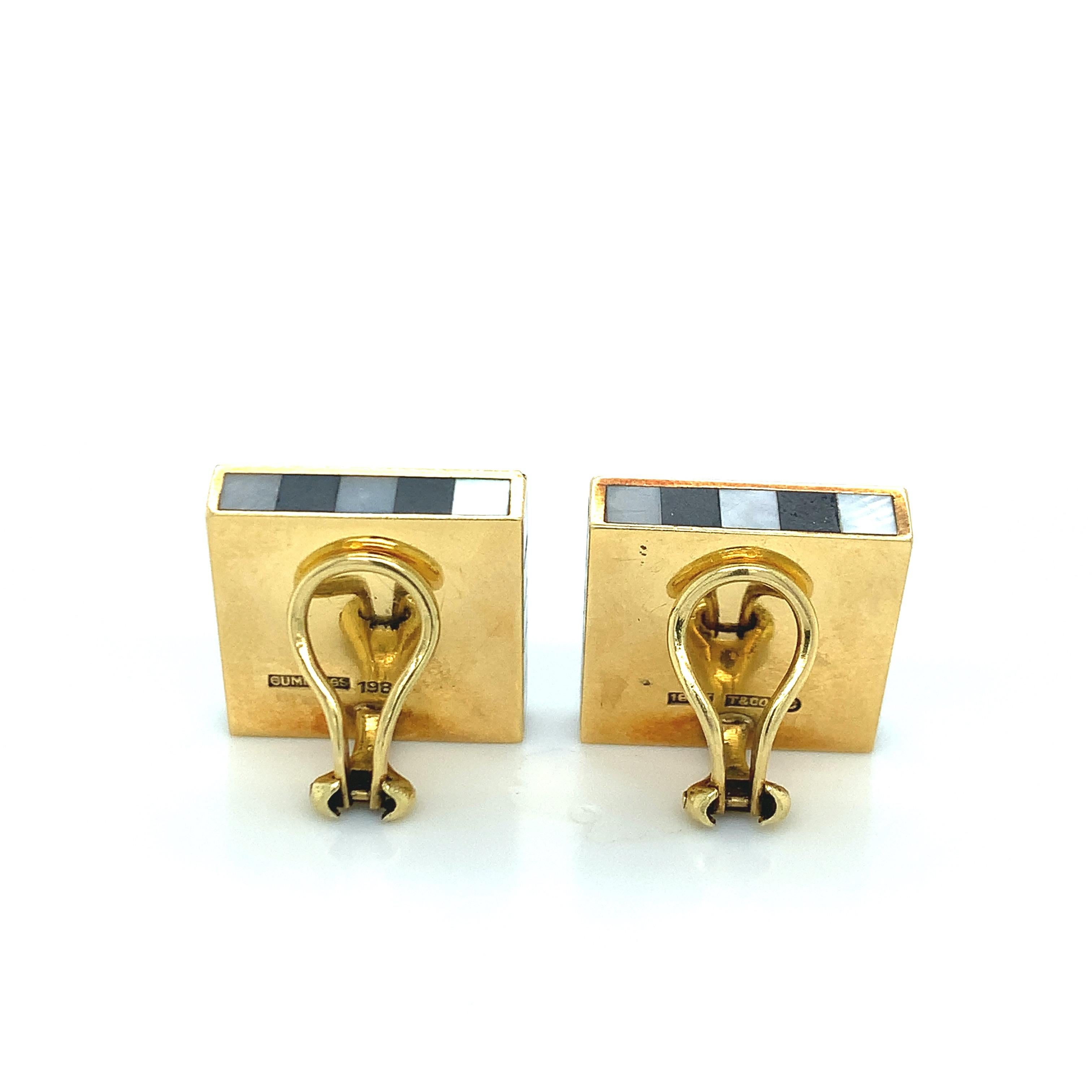 Pair of 18k gold earrings by Angela Cummings, set with inlayed checkered mother of pearl and black jade. Earrings are 0.75 x 0.75