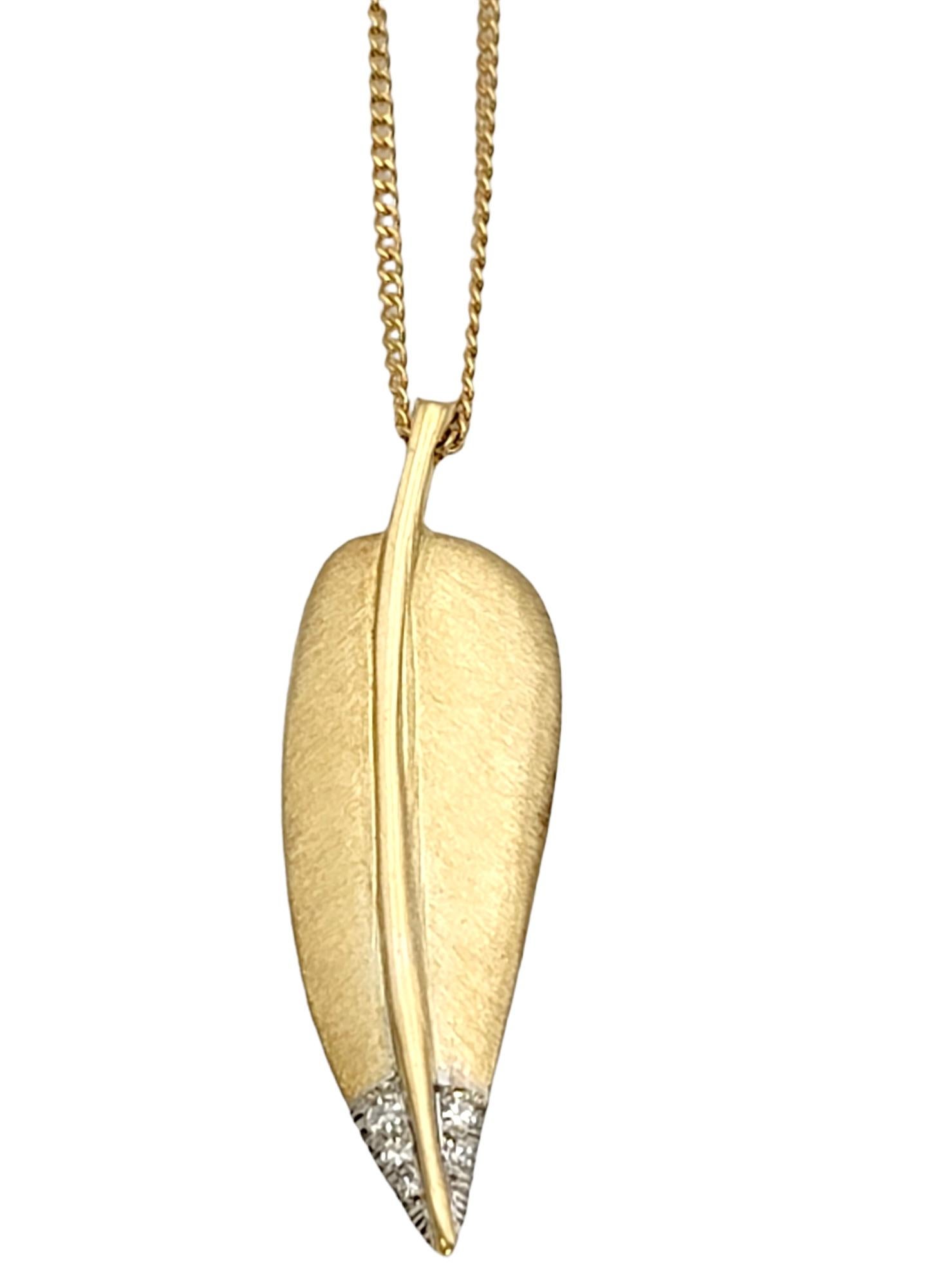 Beautiful vintage feather pendant necklace designed by Angela Cummings for Tiffany & Co.. This gorgeous 18 karat yellow gold piece is simple yet stunning on the neck.  Set on a delicate chain, the feather is done in a softer, brushed finish, while