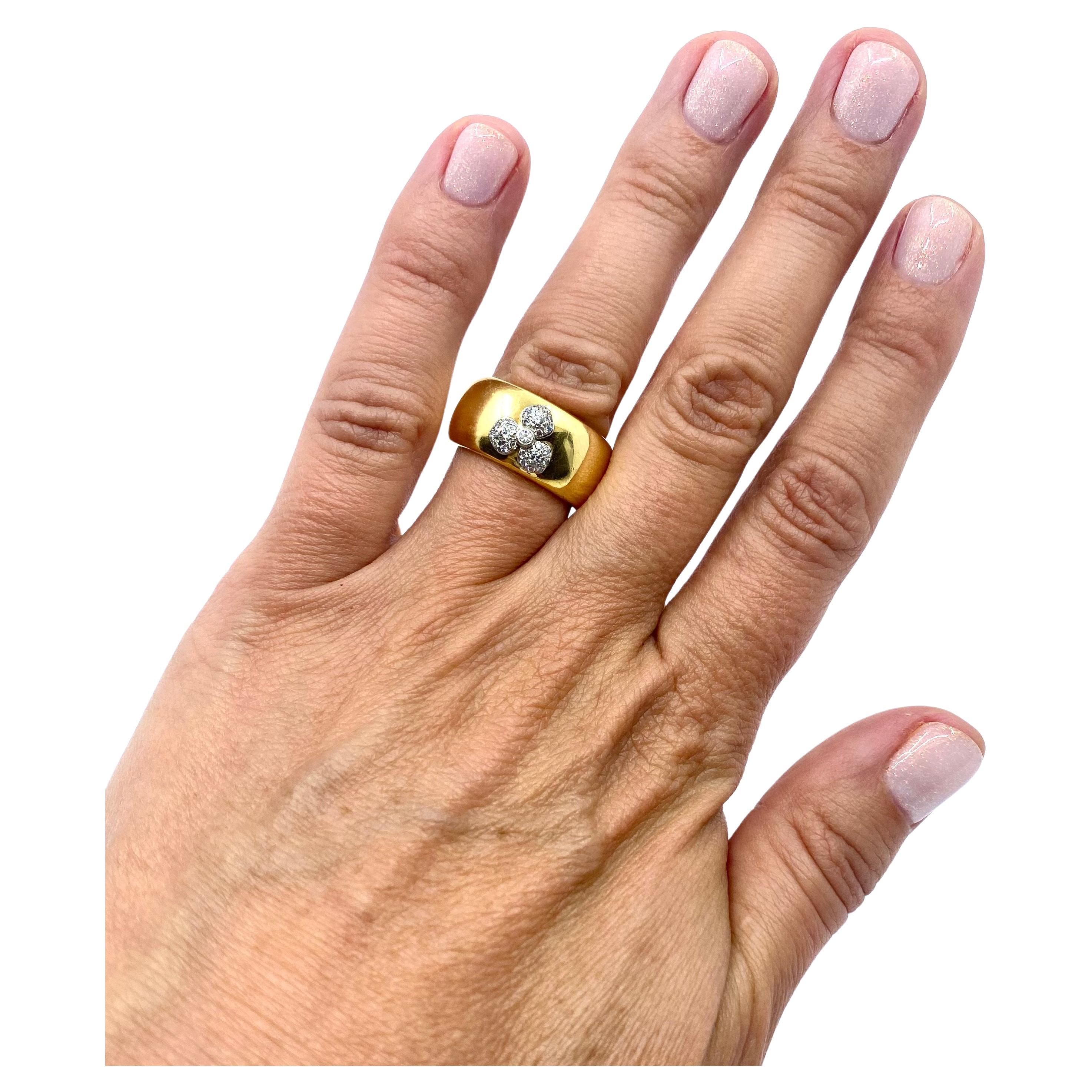DESIGNER: Tiffany & Co.
CIRCA: 2000
MATERIALS: 18k Yellow Gold
GEMSTONE: 0.20 cts. Diamond
WEIGHT: 19.3 grams
RING SIZE: 6.25
HALLMARKS: 2000, Tiffany & Co. , 750, PT950, France

ITEM DETAILS:
A beautiful 18k gold cigar band with diamond by Angela