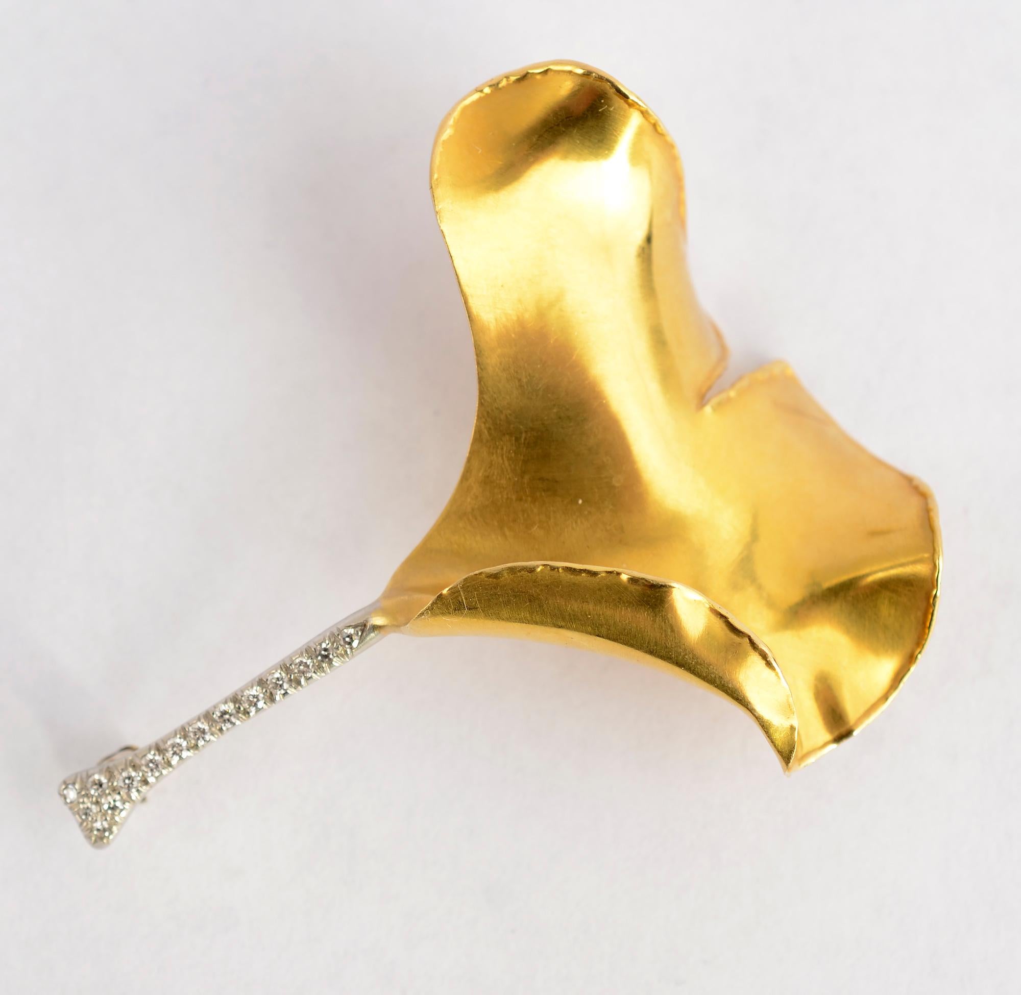 Gold and platinum ginko brooch designed by Angela Cummings for Tiffany. The gold is beautifully sculpted to give the effect of a true leaf. The stem is made of diamonds set in platinum.
The brooch is 2 inches long and 1 3/4 inches at the widest.
