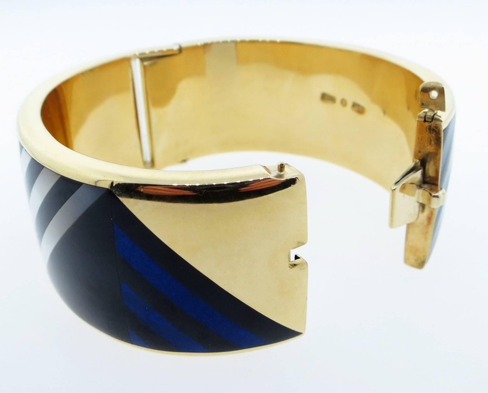 Angela Cummings designed bracelet for Tiffany & Co.  inlaid in a geometric pattern with onyx, mother of pearl and lapis.  Circa 1980. The bracelet measures 1. 1 inches in width and weighs 87.9 gr. Hidden catch signed inside the bracelet.