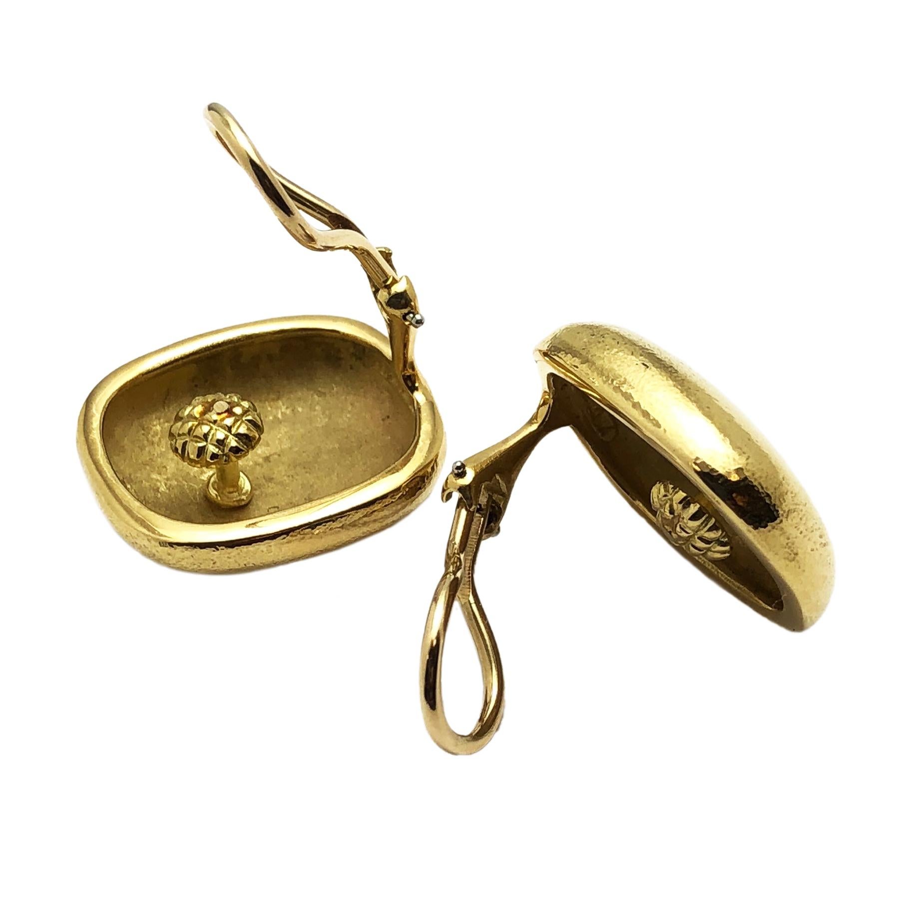Circa 1980s Angela Cummings for Tiffany & Company 18K Yellow Gold Cushion shape Earrings with a light Hammered finish. Measuring 7/8 X 3/4 inch and 1/4 inch thick. Weighing 21 Grams, having Omega clip backs to which a post can be easily added if