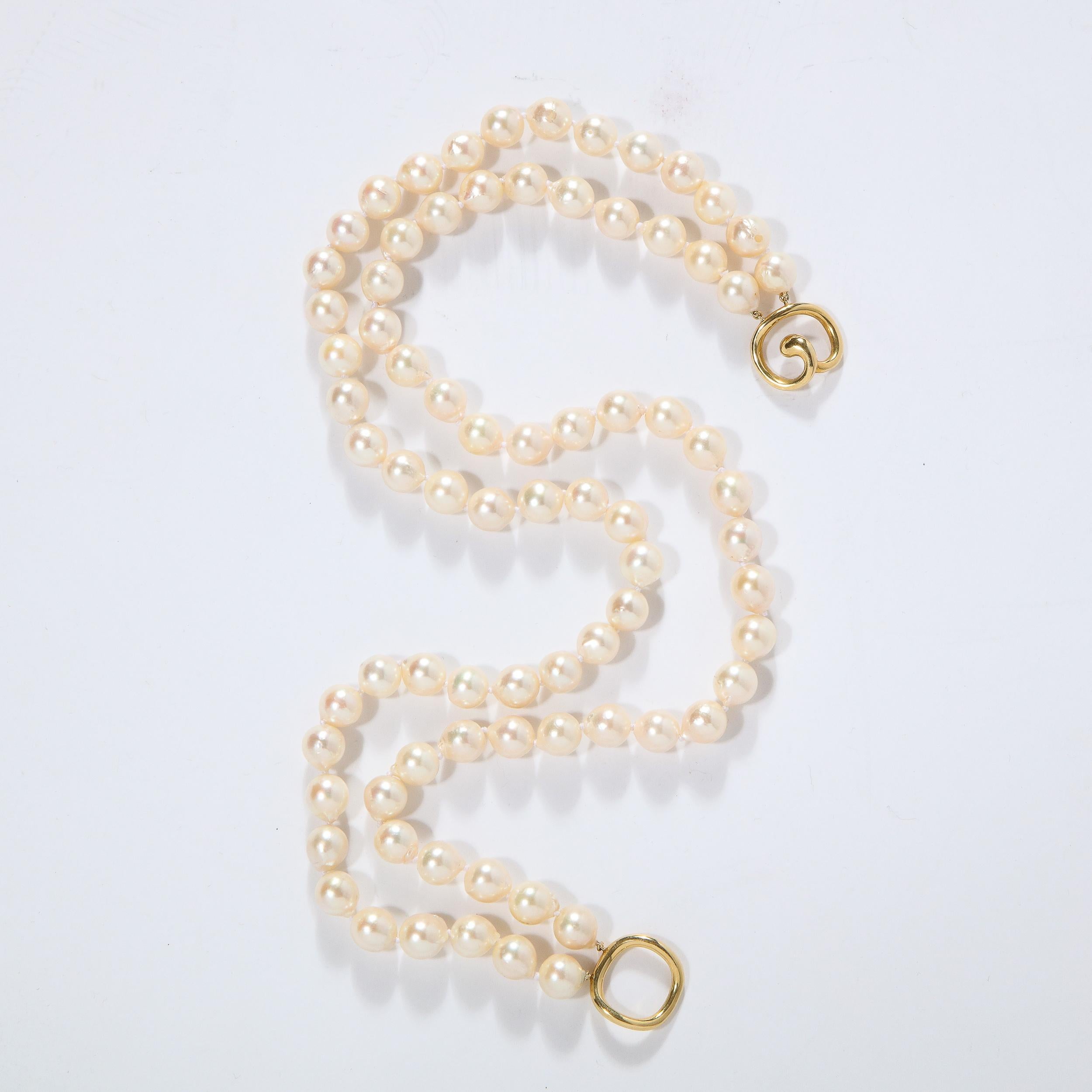 Necklace signed Angela Cummings double strand of hand knotted pearls with an modernist 18k yellow gold clasp. Pearls average approximately 9mm. Stamped 1984 Cummings 18k. Total weight of the necklace is 60.5 grams. It has been newly restrung and is