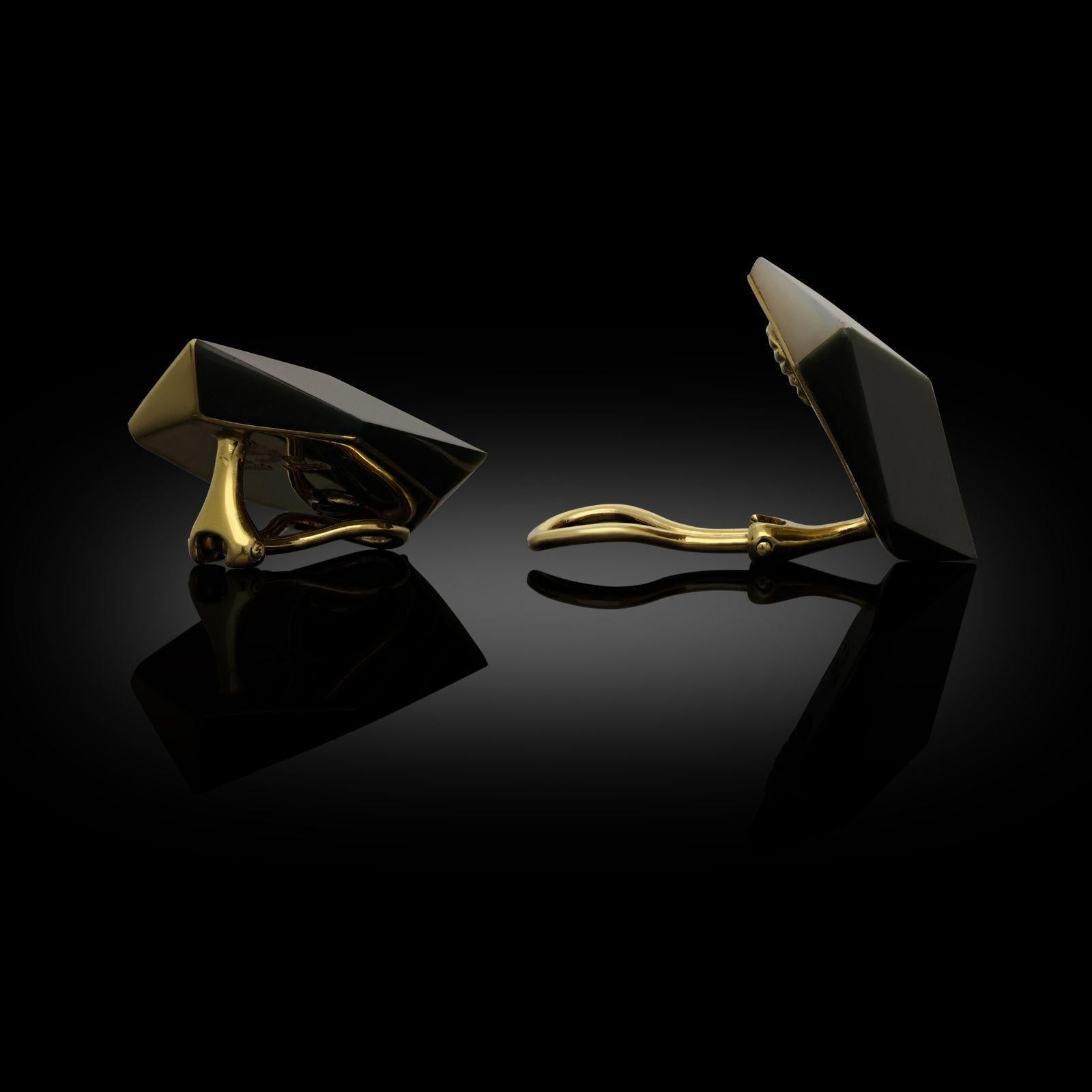 A striking pair of geometric ear clips by Angela Cummings c.1980s, each designed as a three-dimensional image of a cube with each of the three faces in either finely textured 18ct yellow gold with a satin finish, mother of pearl inlay or black onyx