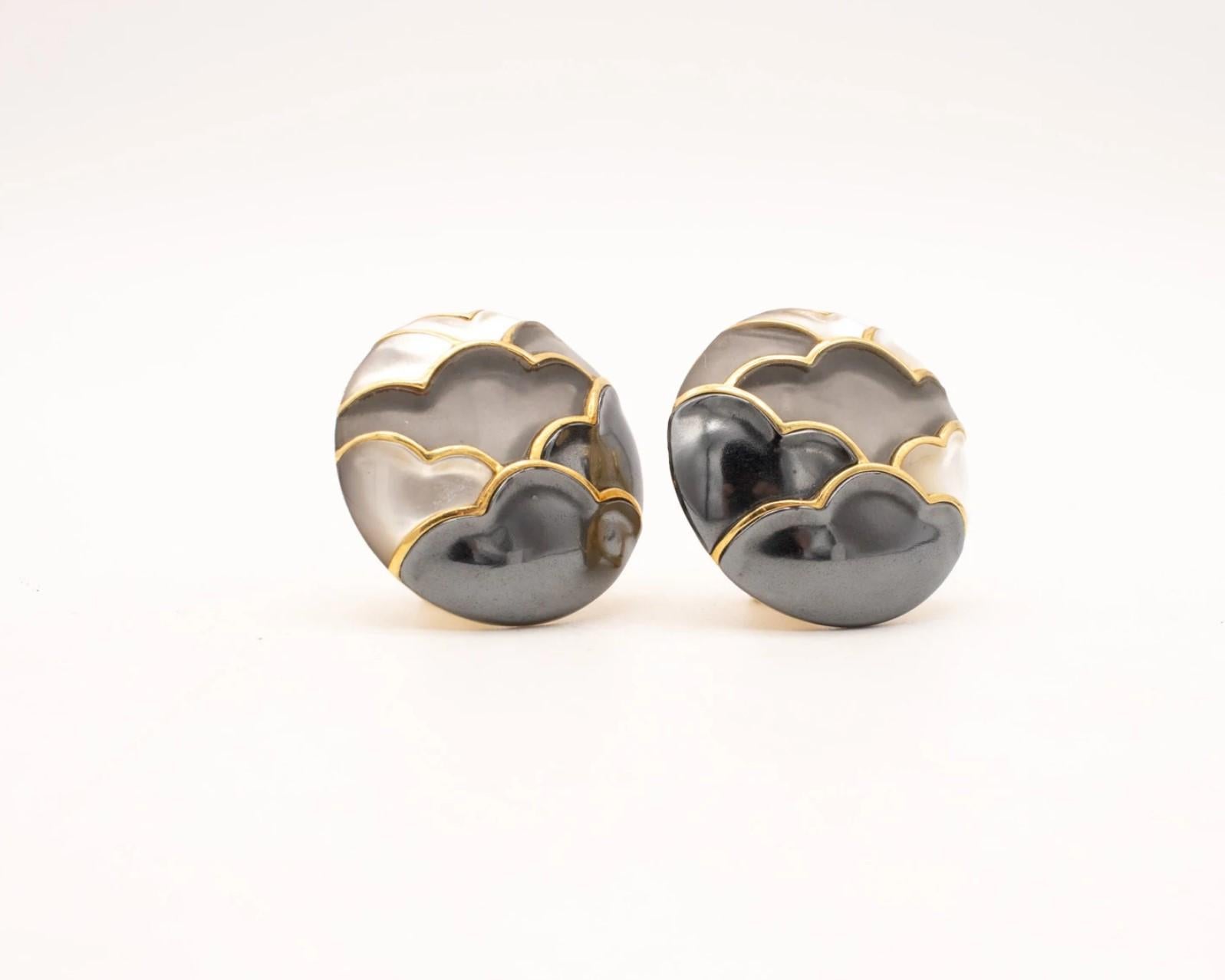 Unusual pair of ear-clips designed by Angela Cummings.

A rare one-of-a-kind vintage pair of clips-earrings designed as a Japonisme landscape abstraction of clouds and mountains. This gorgeous pair has been created by Angela Cummings back in the