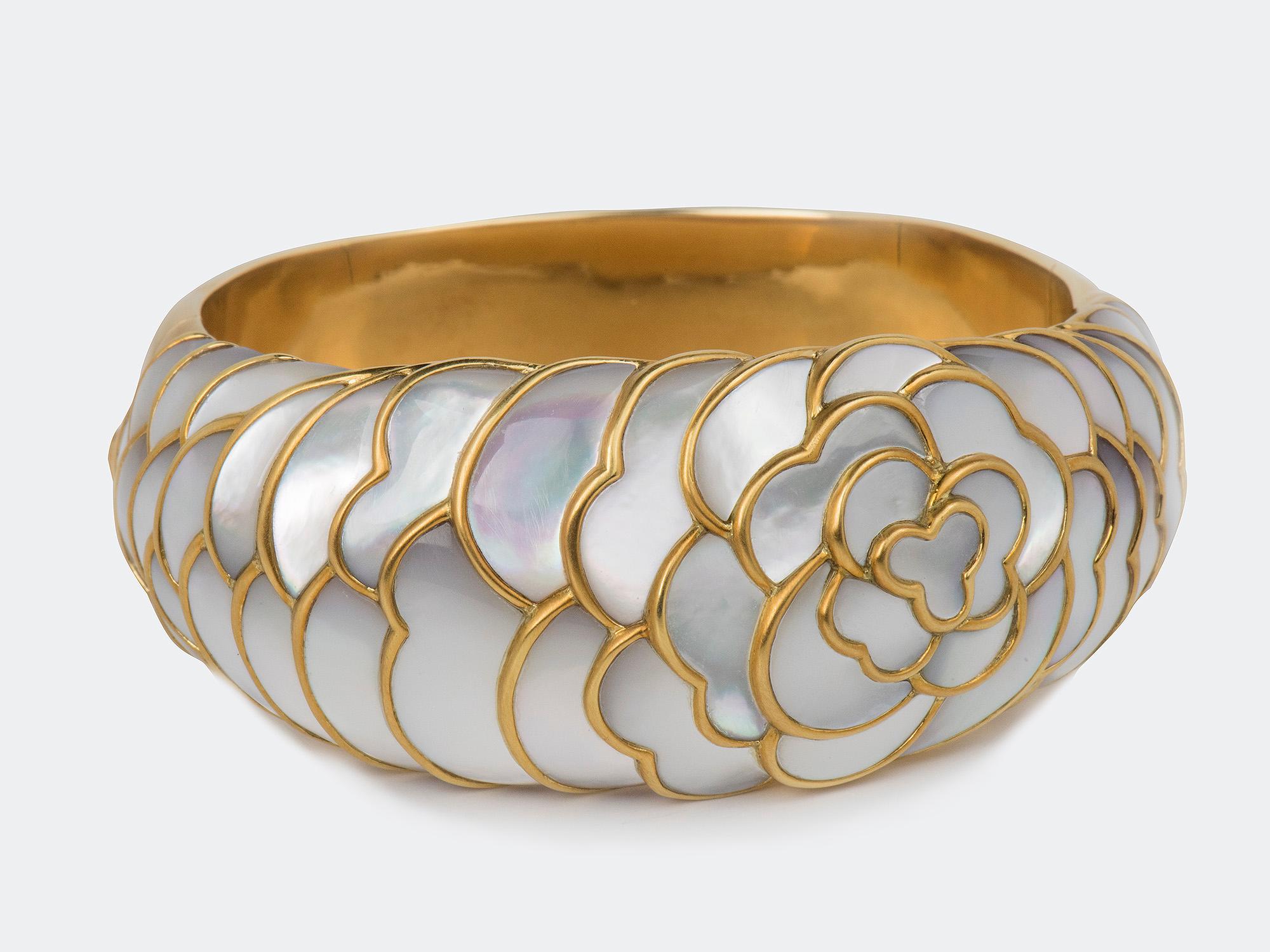 18k gold Camilla motif cuff by Angela Cummings, circa 1980. Inner 6-1/2 inches and 1-1/4 inches wide. Signed ANGELA CUMMINGS 750.
