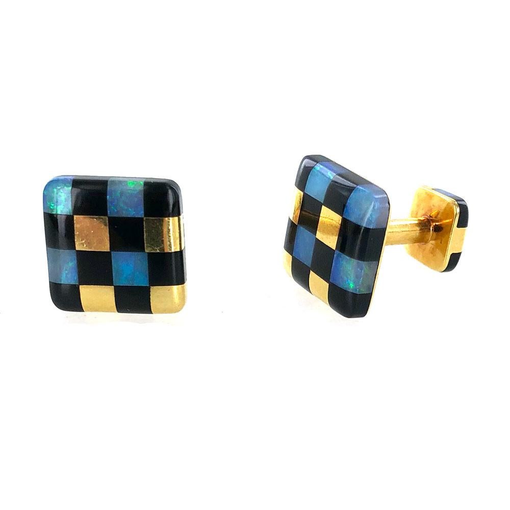 These fabulous 18 karat yellow gold cufflinks are by designer Angela Cummings. The cufflinks feature opal and black jade inlayed gemstones. The cuffs measure 15.5 x 15.5mm and weigh 11.9 grams. Signed Angela Cummings 18k 1984. All of the gemstones
