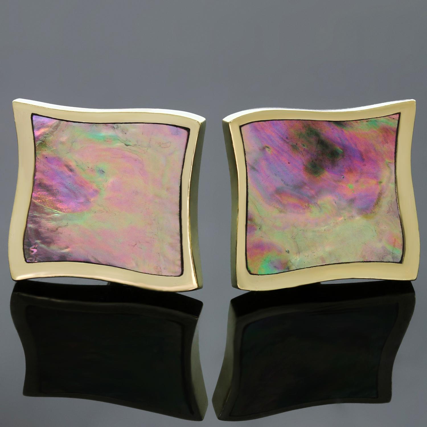 These rare ethereal Angela Cummings lever-back earrings earrings are crafted in 18k yellow gold and feature carved multi-colored paula shells measuring 23.0mm x 25.0mm. Made in United States circa 1990s. Measurements: 0.90