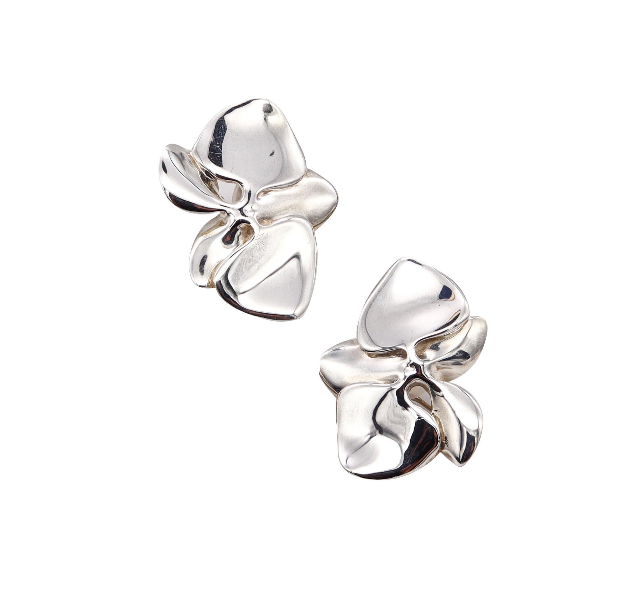 Orchids Earrings designed by Angela Cummings.

An over-sized organic sculptural piece, created in New York city by Angela Cummings back in the 1984. This pair of earrings was carefully crafted at her own studio in solid sterling silver with very