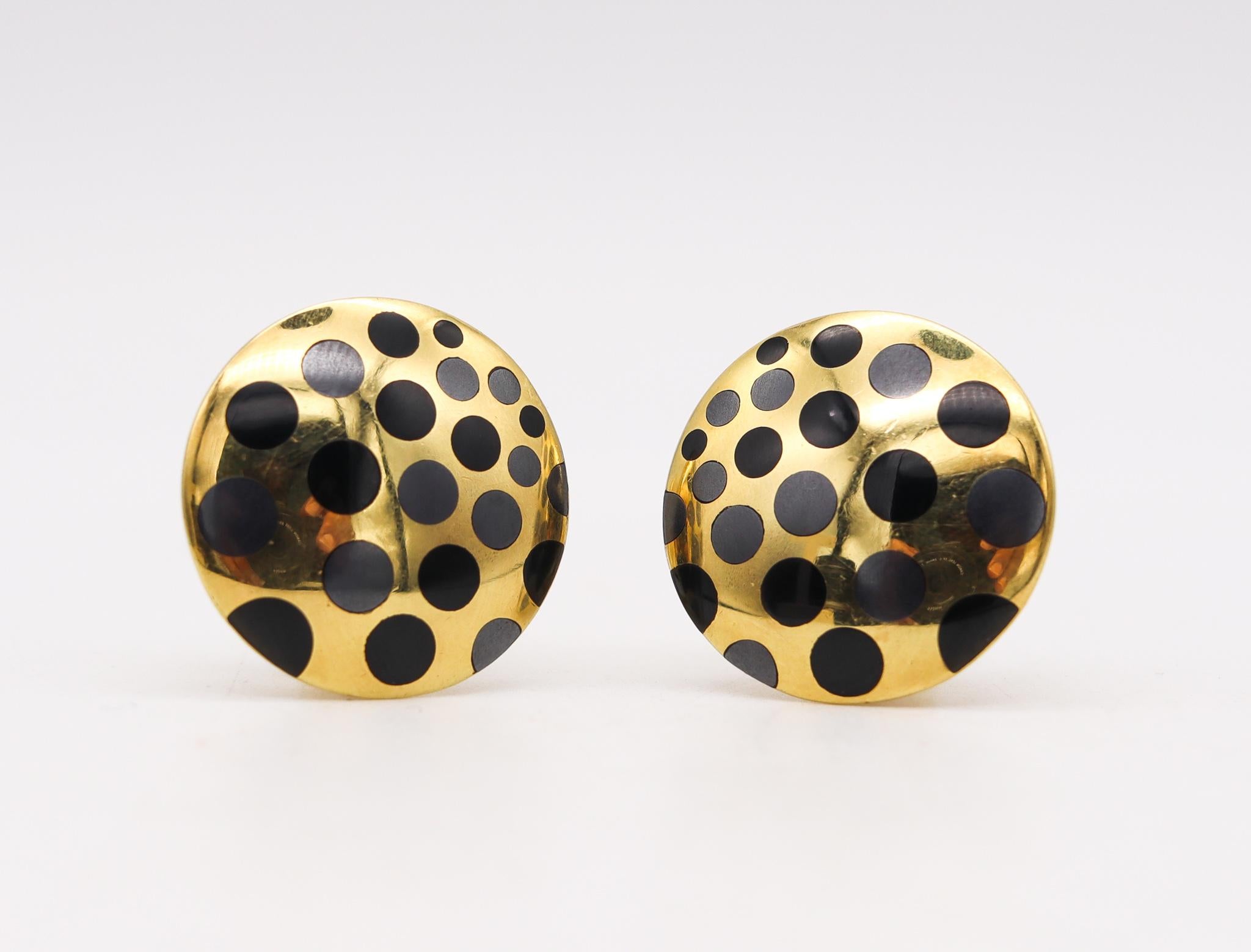 Geometric dotted clip earrings designed by Angela Cummings.

Very beautiful pair, created by Angela Cummings at her studio in New York, back, back in the early 1980's. These very modernist round clips earrings has been crafted in solid yellow gold