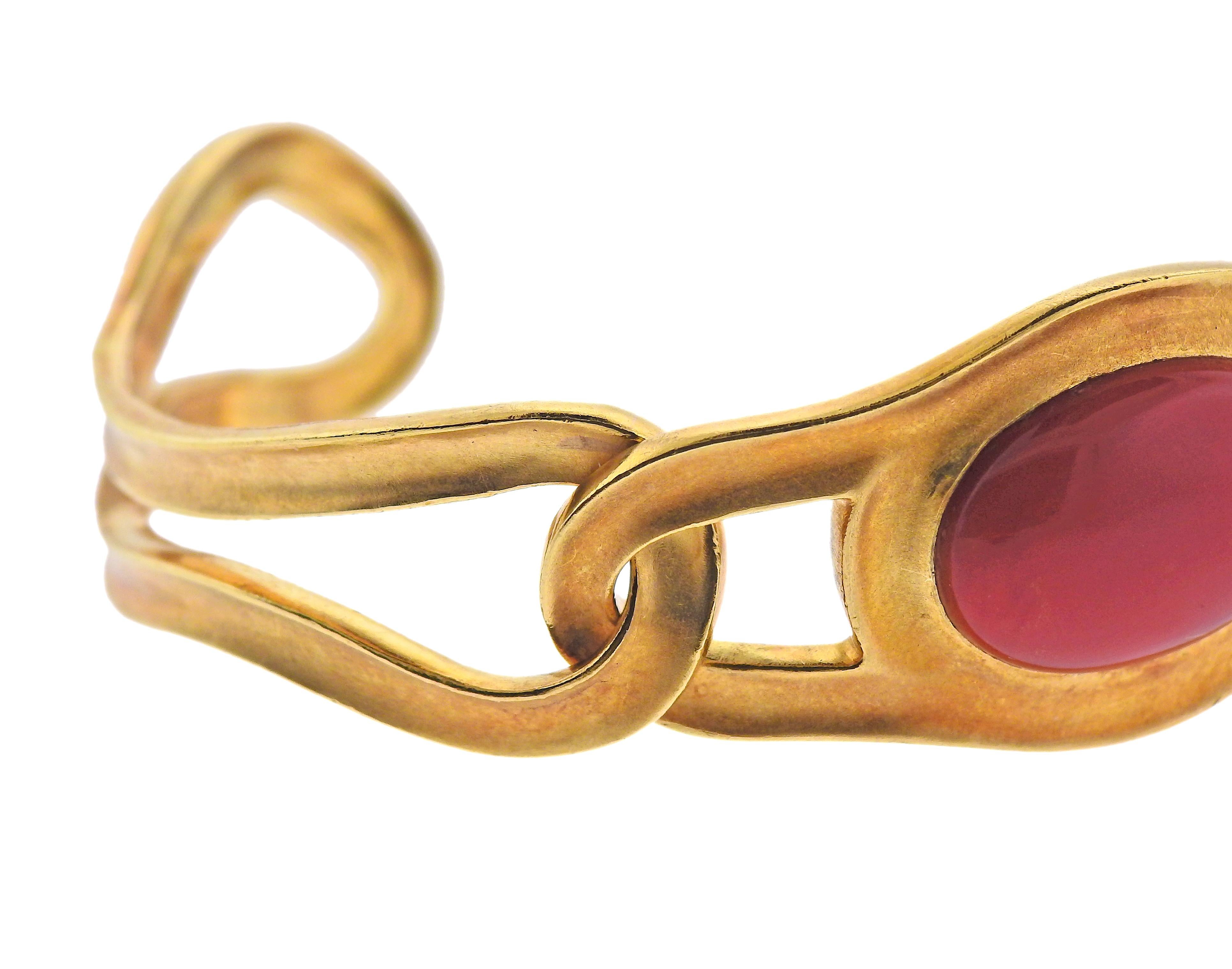 CIrca 1982, 18k gold bangle bracelet by Angela Cummings for Tiffany & Co, with 18mm x 13mm coral. Bracelet will fit approx. 6.5