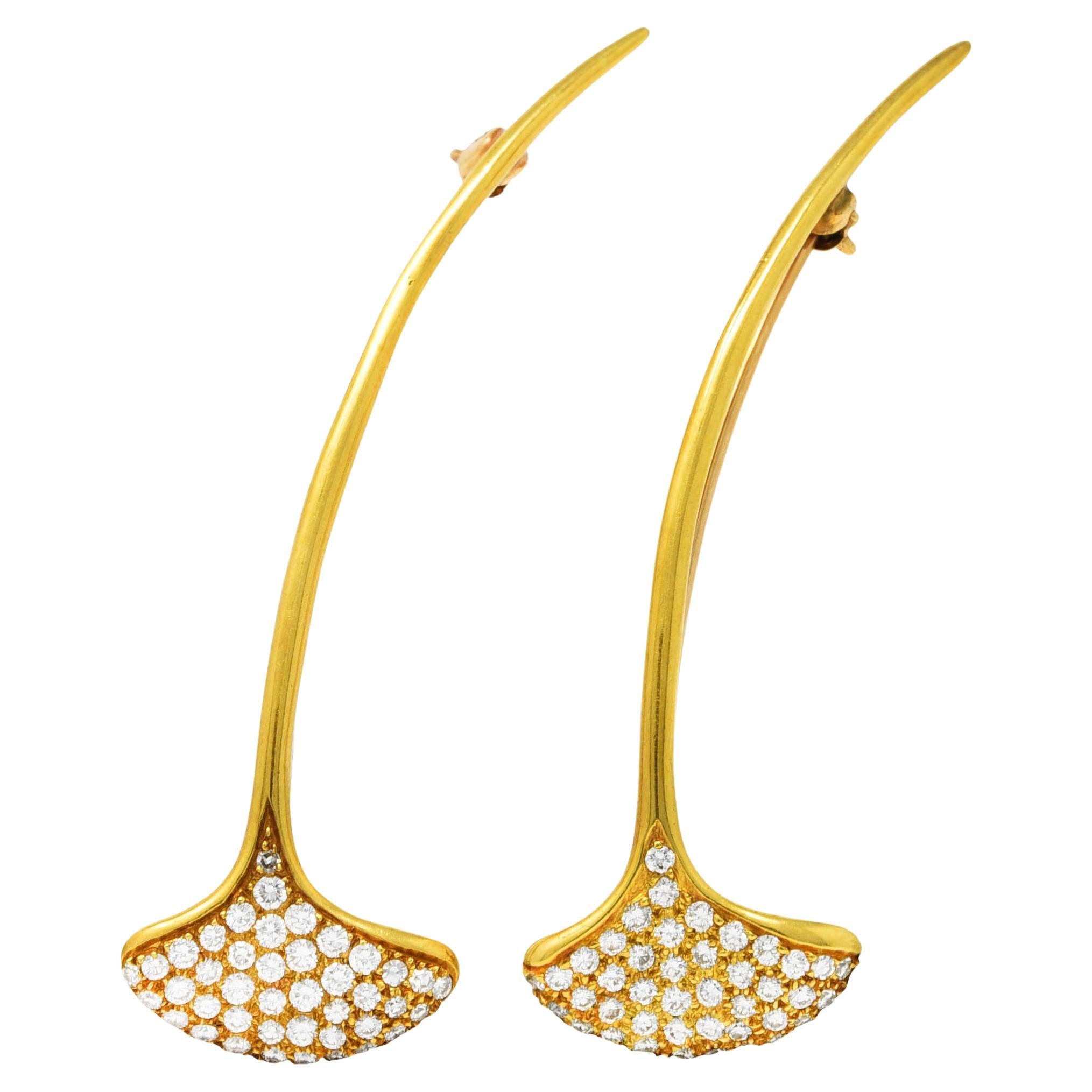 Set of linear bar brooches designed as stylized ginkgo leaves with an elongated polished gold stem. Leaves are pavè set with round brilliant cut diamonds. Weighing in total approximately 1.00 carat - F color with VS clarity. Both completed by a pin