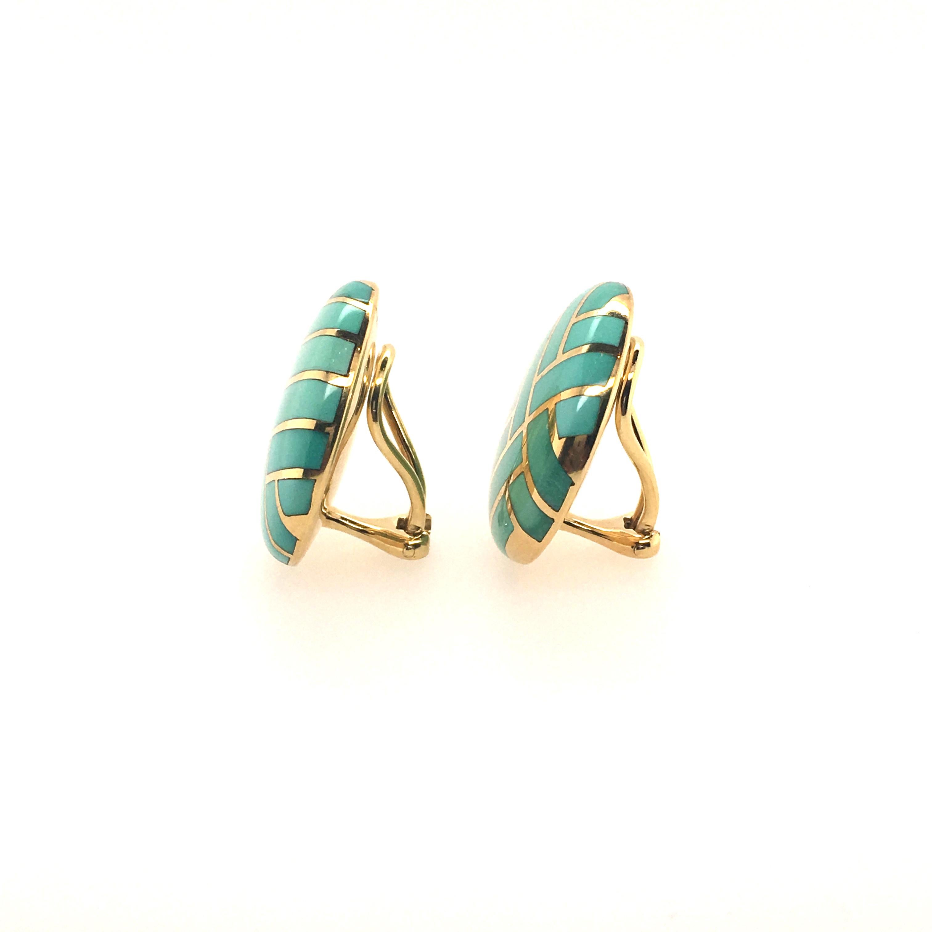 A pair of 18 karat yellow gold and turquoise earrings. Angela Cummings, 1986. Designed as a disc, set with inlayed turquoise. Diameter is approximately 1 inch, gross weight is approximately 18.7 grams. Stamped Cummings, 18K, 1986.