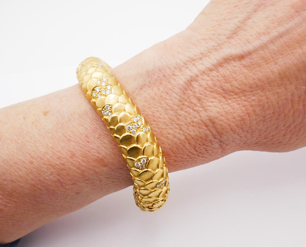 A fabulous stylized snake bracelet created by Angela Cummings in 1986. 
People were always fascinated by snakes and since ancient times that fascination has made snake motif widely used in jewelry.
This vintage bracelet is made of 18 karat yellow