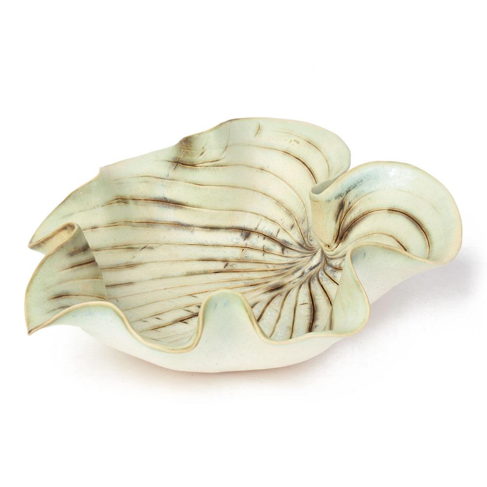 A stylish studio ceramic bowl modelled as a large open leaf with raised edges and with incised veining to the inside of the bowl by Cambridgeshire potter Angela Mellor. The ceramic bowl is decorated in pale matt green glazes with brown applied to