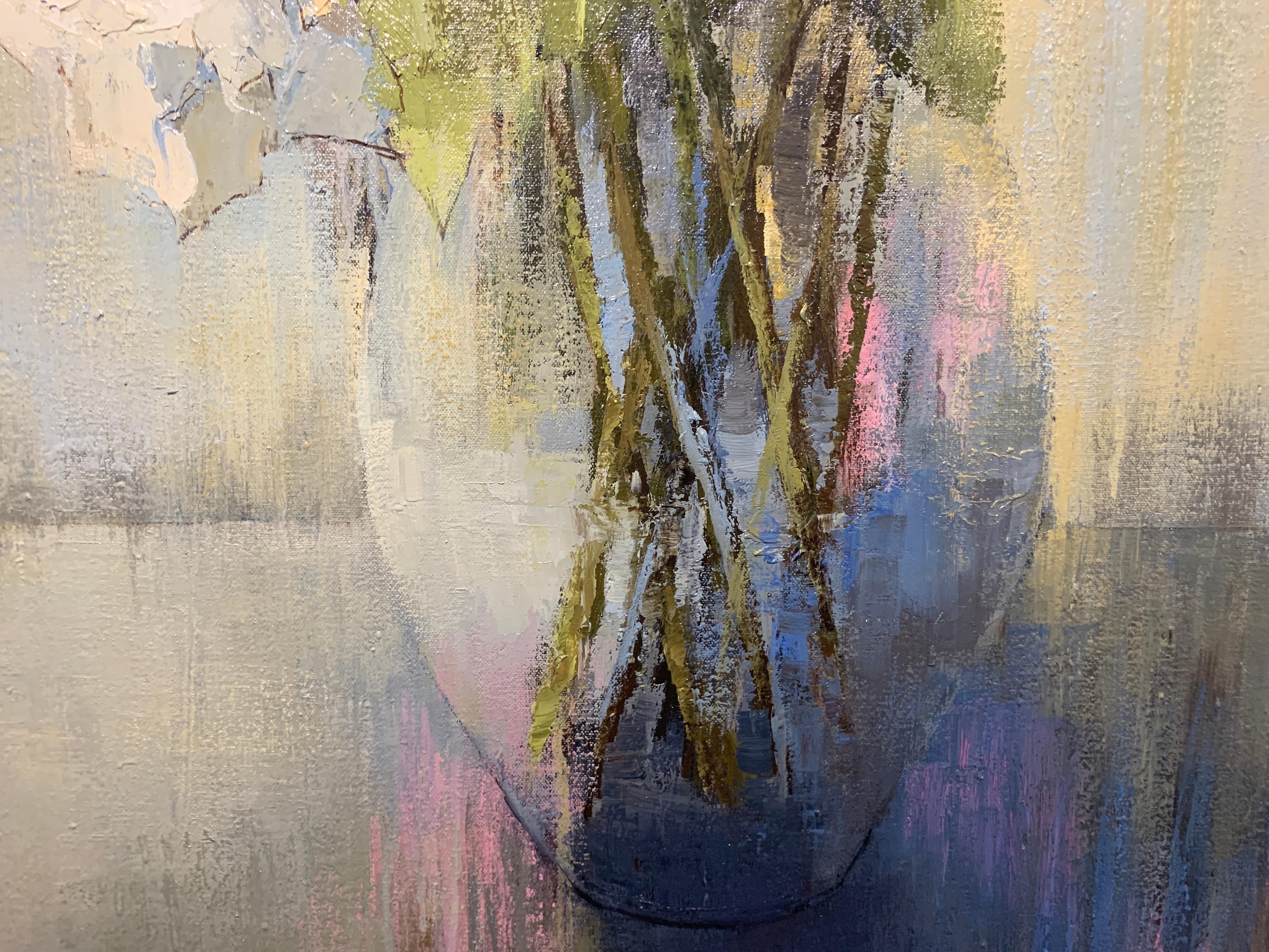 'Ladies of Sophistication' is an American Impressionist floral oil on canvas painting created by Angela Nesbit in 2019. Going to the essentials, the artist depicted a bouquet of white flowers, resting in a simple glass vase. With a loose stroke and