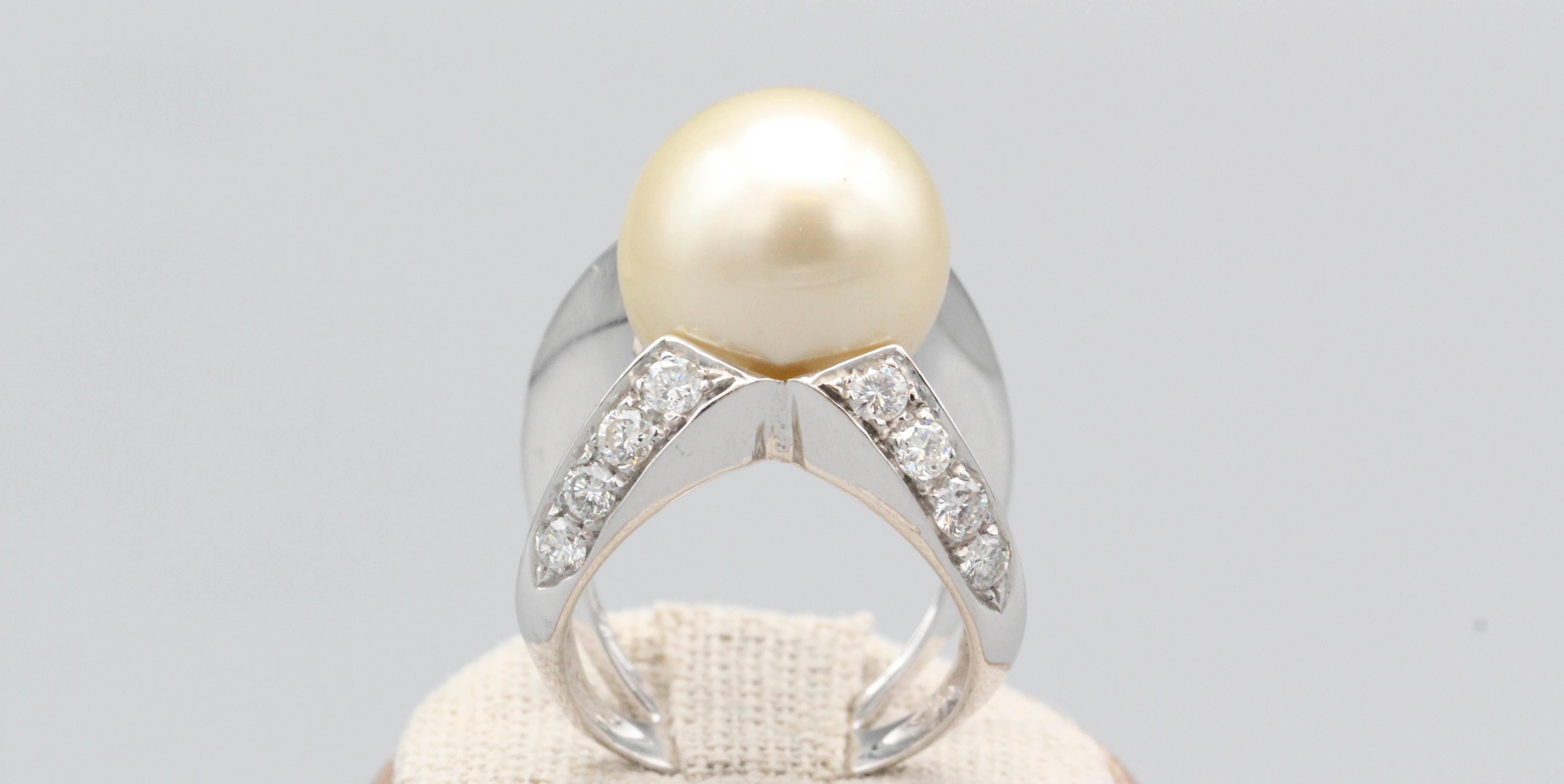 Fine cultured pearl and diamond ring set in 18k white gold, by Angela Pintaldi.  Featuring a 15 mm wide golden white South Sea pearl and approx. 1.5 carats of high grade white diamonds in an unusual octopus-like setting.  

Hallmarks: Angela