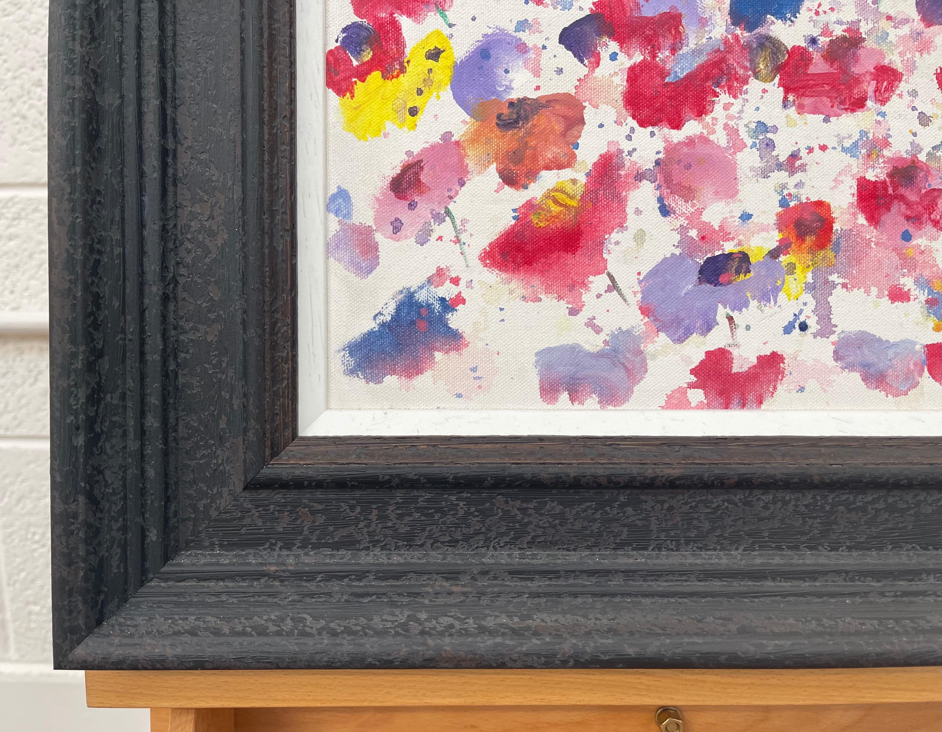 Painting of Abstract Red, Blue & Yellow Wild Flowers on a White Background by British Contemporary Artist, Angela Wakefield. This original is from the 'Spring Burst' Interior Design Series. Framed in a high quality off-black contemporary wooden