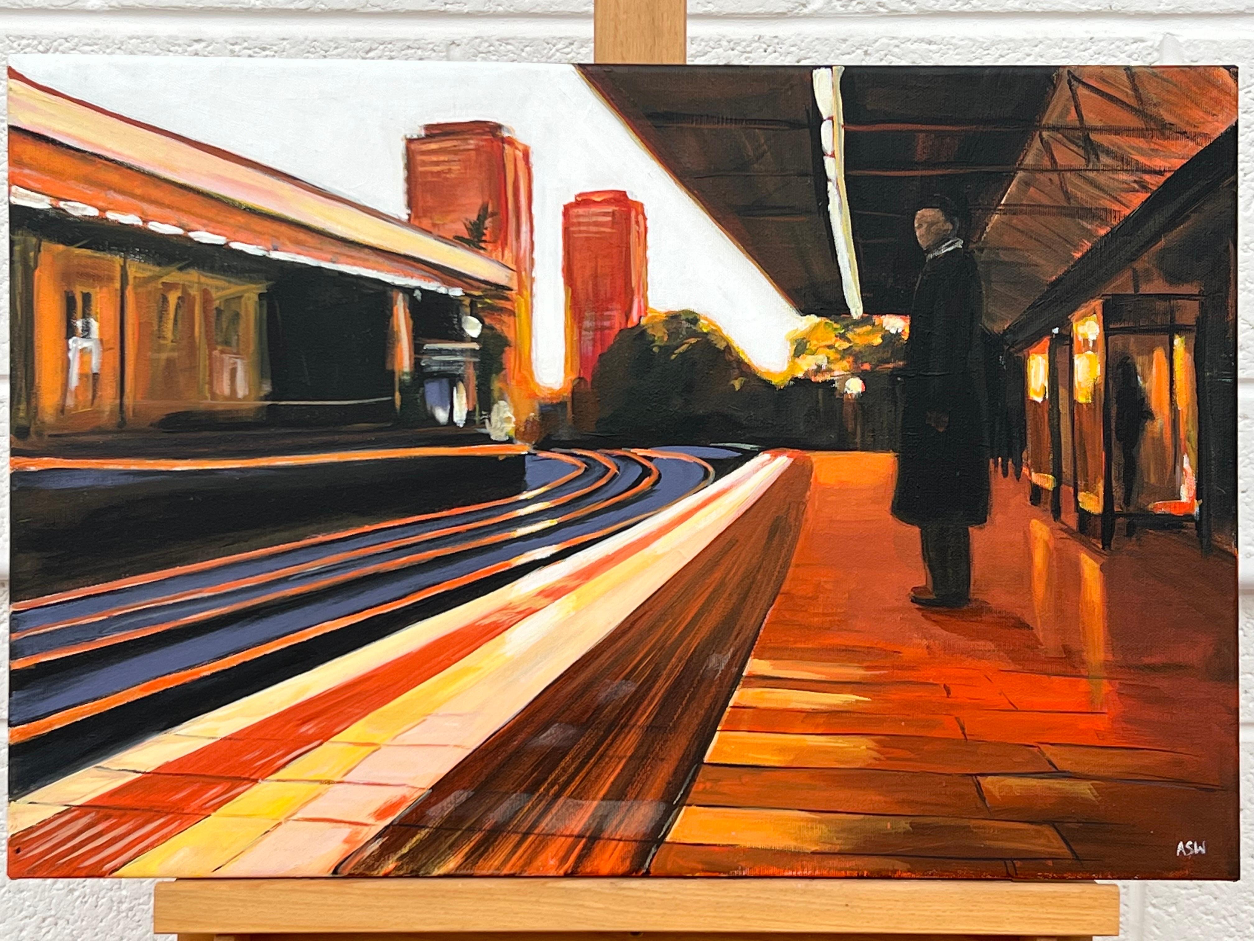 Painting of Train Station in London England by Leading Contemporary British Urban Landscape Artist, Angela Wakefield. This original depicts a sole figure standing in an empty station, in Westbourne Park, London, using a limited palette of oranges