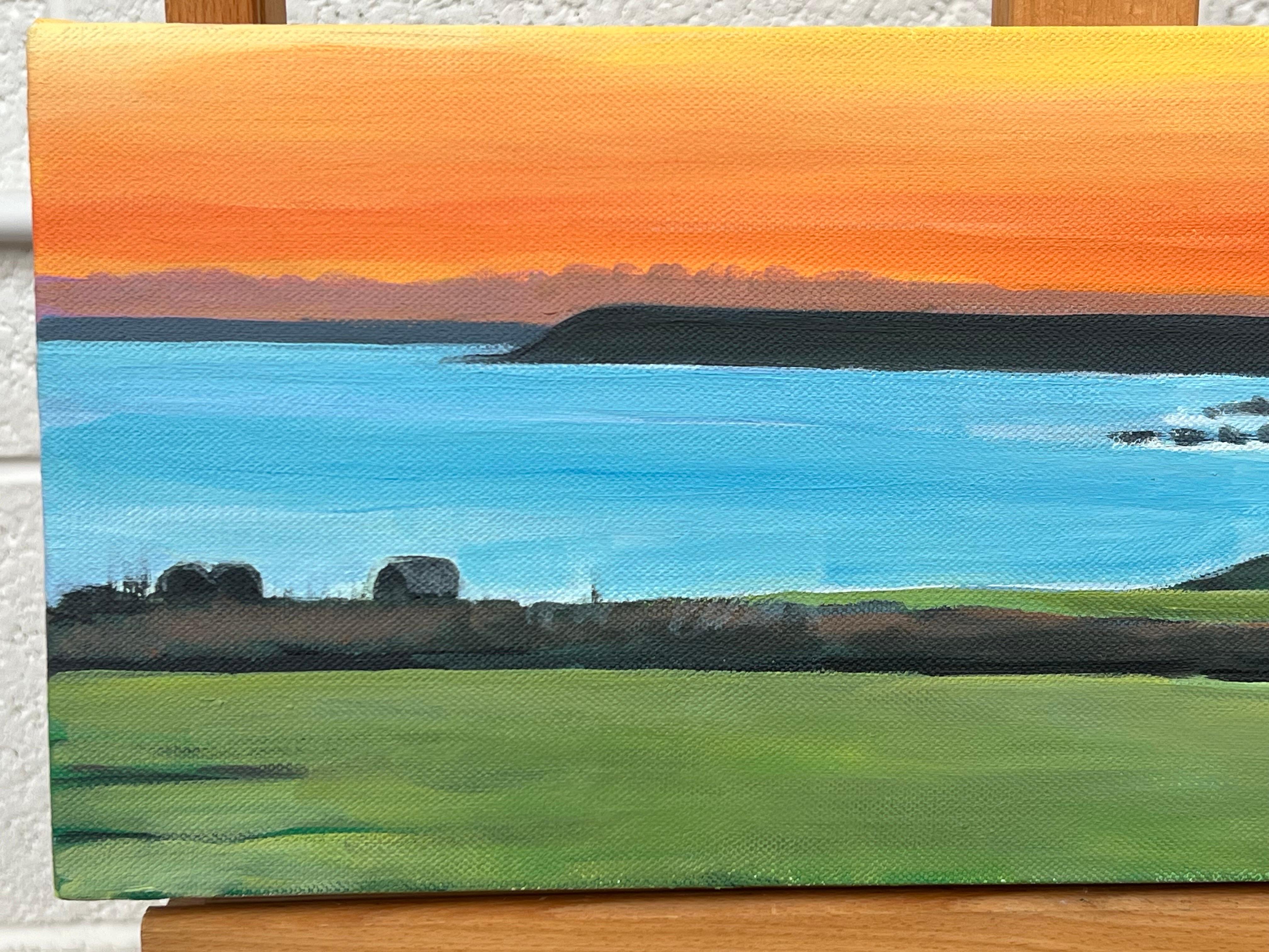 Escena panorámica de la costa de Devon con puesta de sol naranja en el Canal de la Mancha, por la artista británica contemporánea Angela Wakefield. 

La obra mide 20 x 8 pulgadas 
(lienzo caja sin enmarcar) 

Este cuadro representa un sereno paisaje