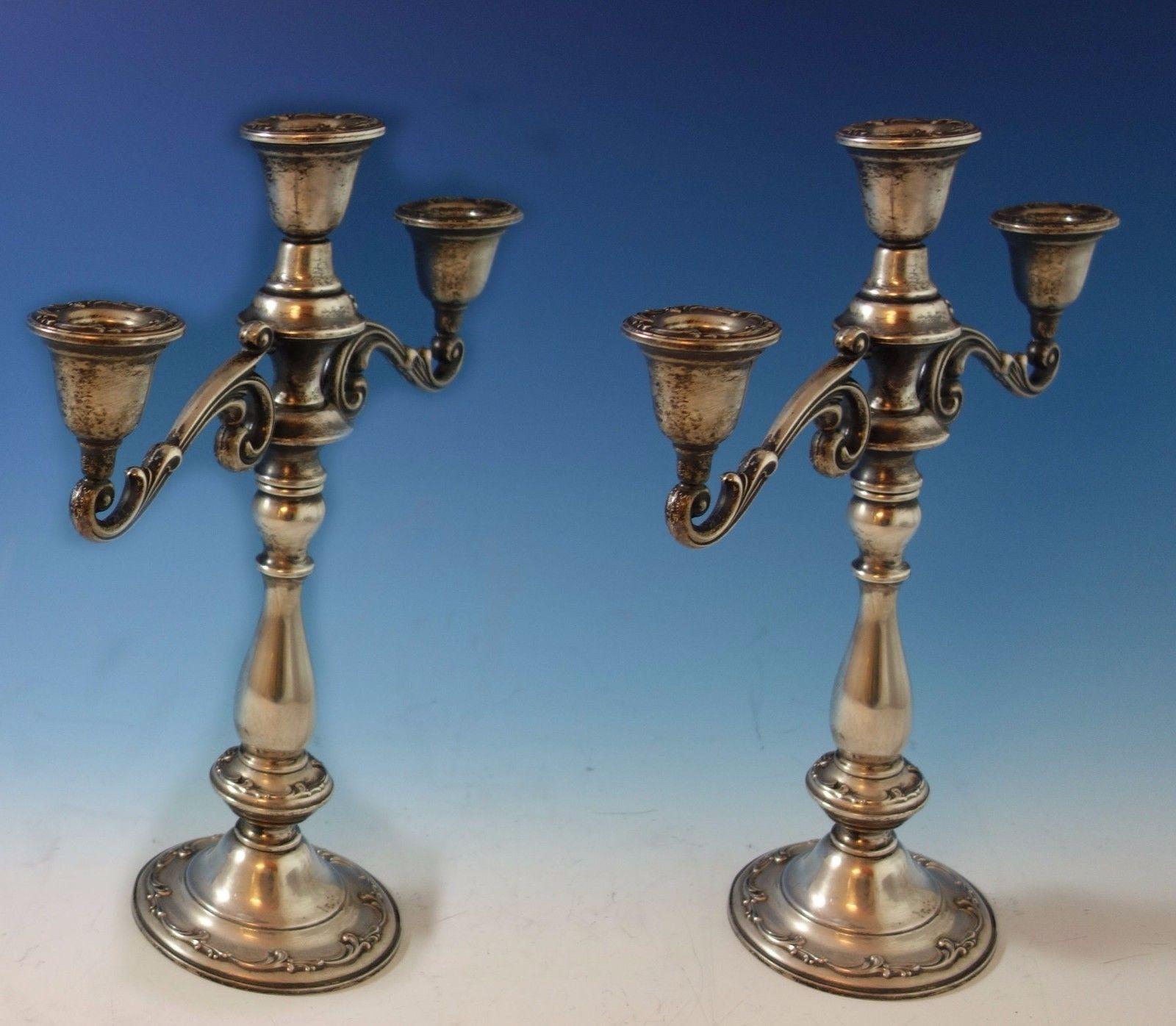 Angelique by International sterling silver pair of candelabras (weighted). The candelabras are 3-light and are marked with #127/65. The pair measures 13 1/2 tall and 12 wide. They are not monogrammed and are in excellent condition. Impressive.