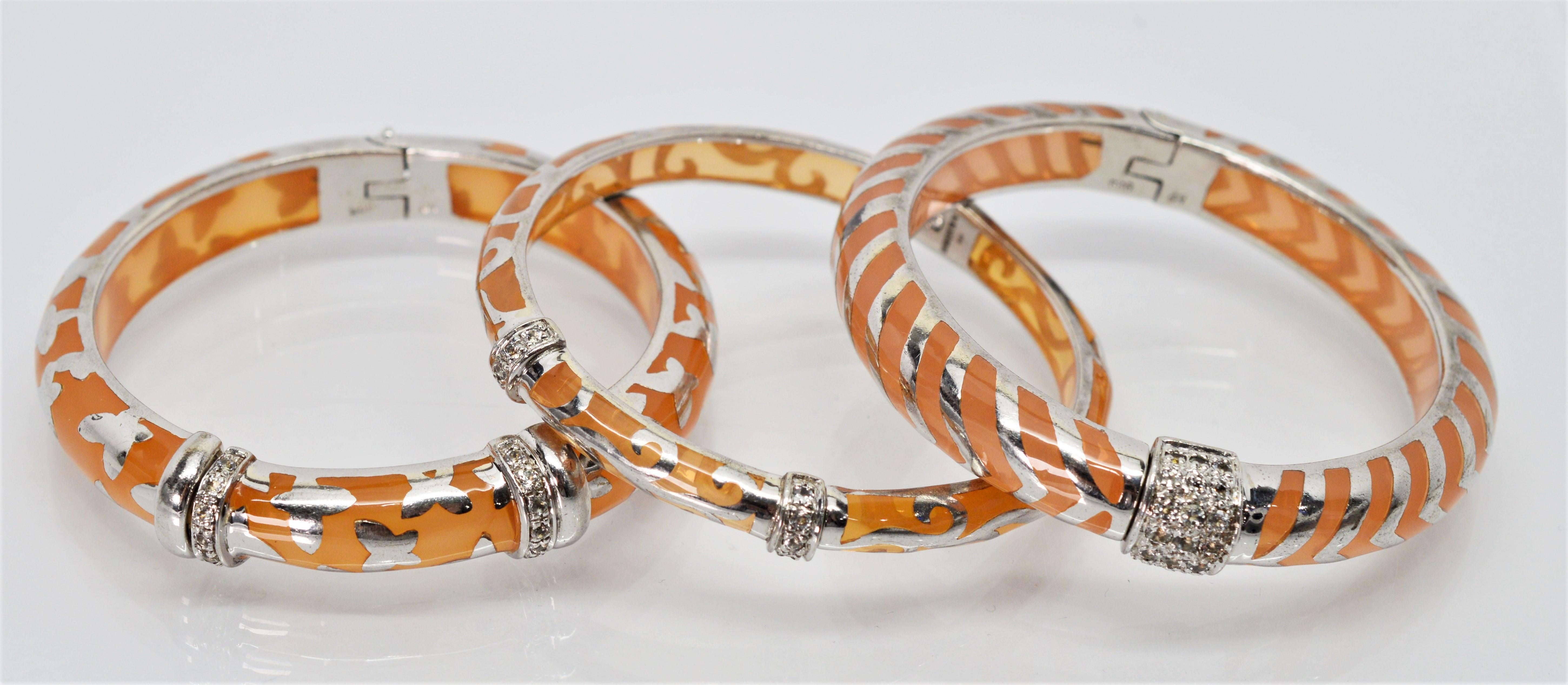 Wearable works of art describe this modern trio of Angelique de Paris Bangle Bracelets. Three complementing styles in Angelique's signature peach
resin and sterling silver with a platinum rhodium finish and round cut white topaz stations. Each