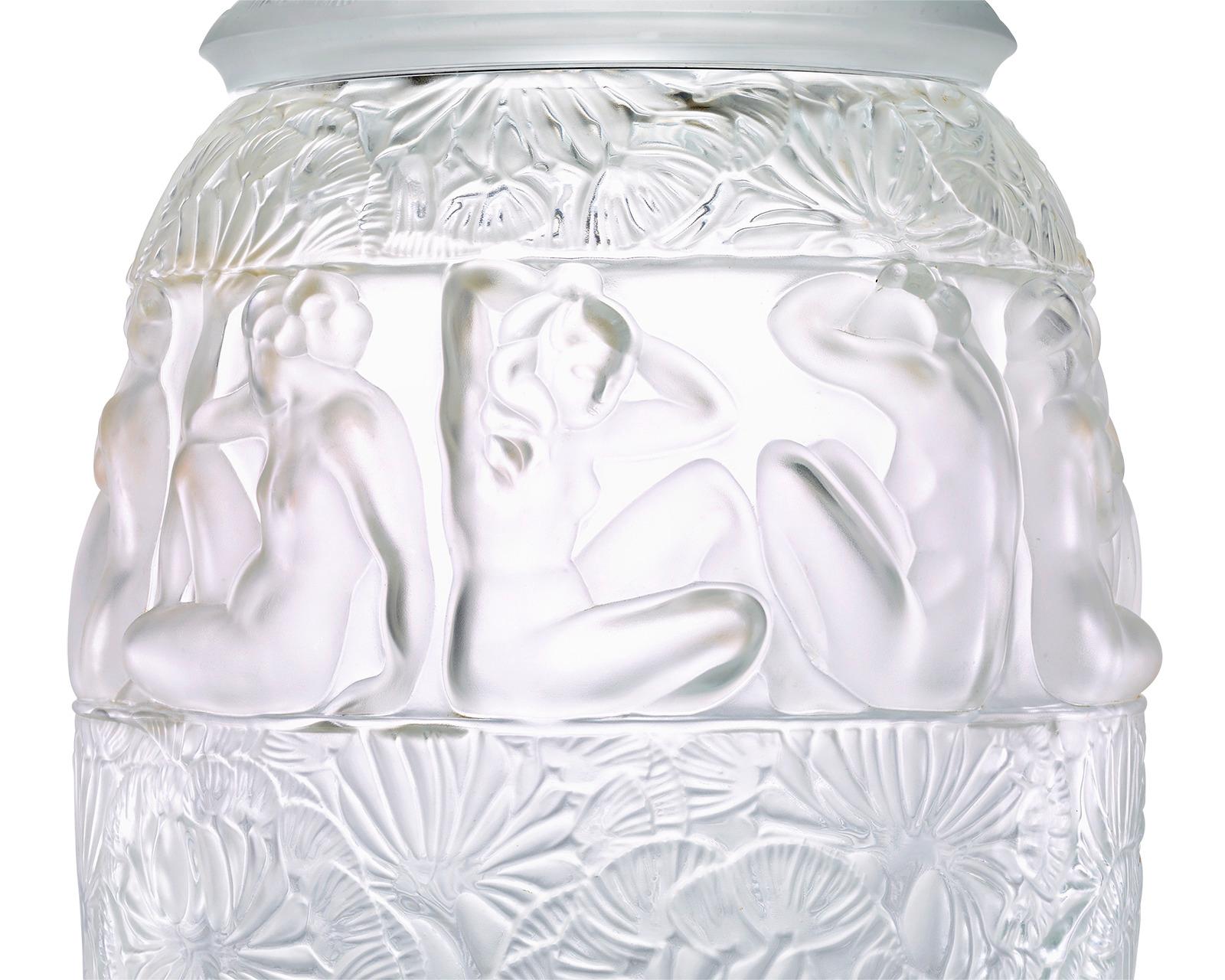 A dramatic floral motif engulfs this impressive Art Deco-style lidded glass vase by the iconic firm Lalique. Known as the Angélique, the monumental piece is an extraordinary example of Lalique's excellence in glassmaking, bringing together both a