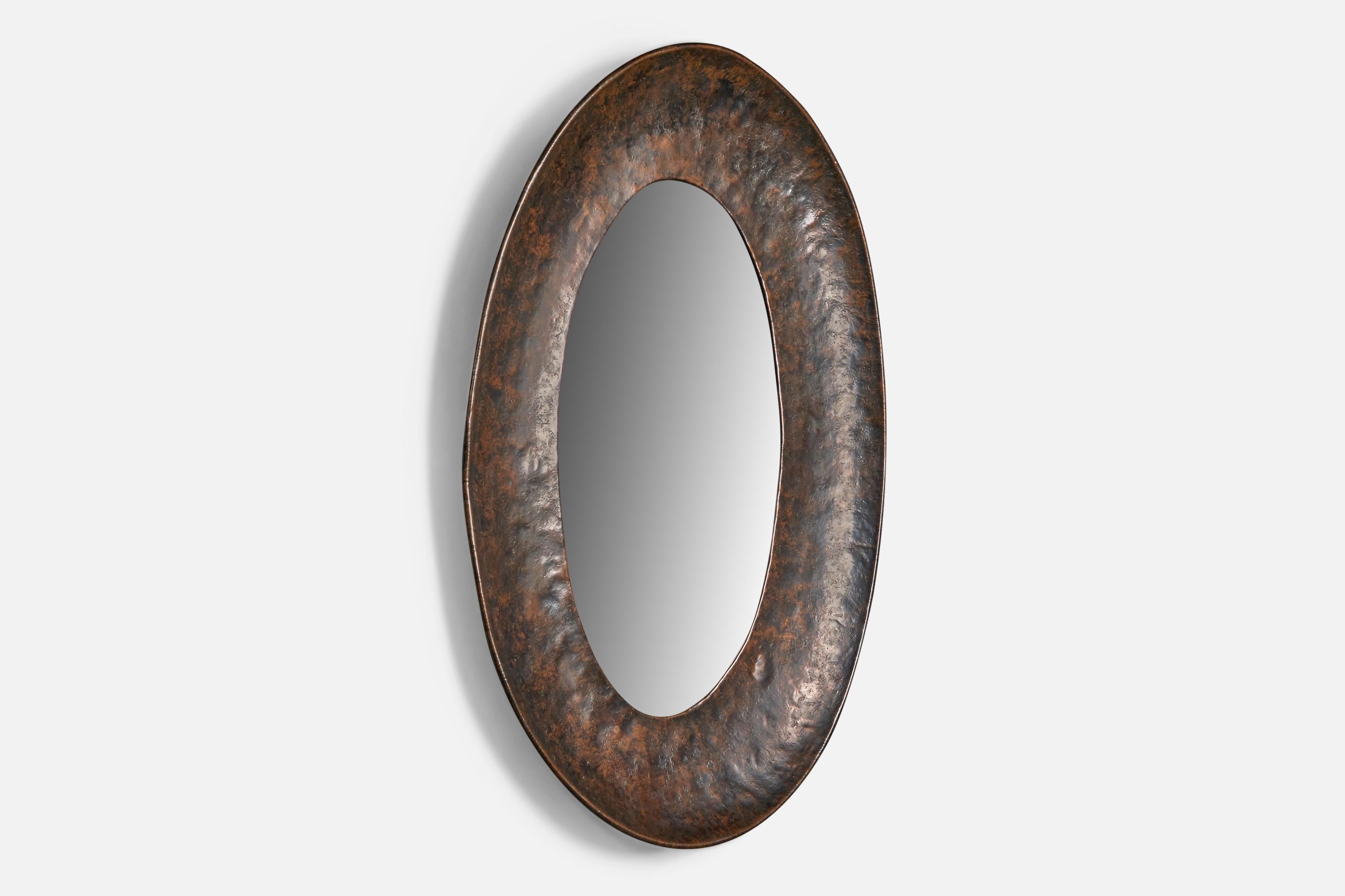 A patinated and hammered copper wall mirror, designed and produced by Angelo Bragalini, Italy, 1960s.