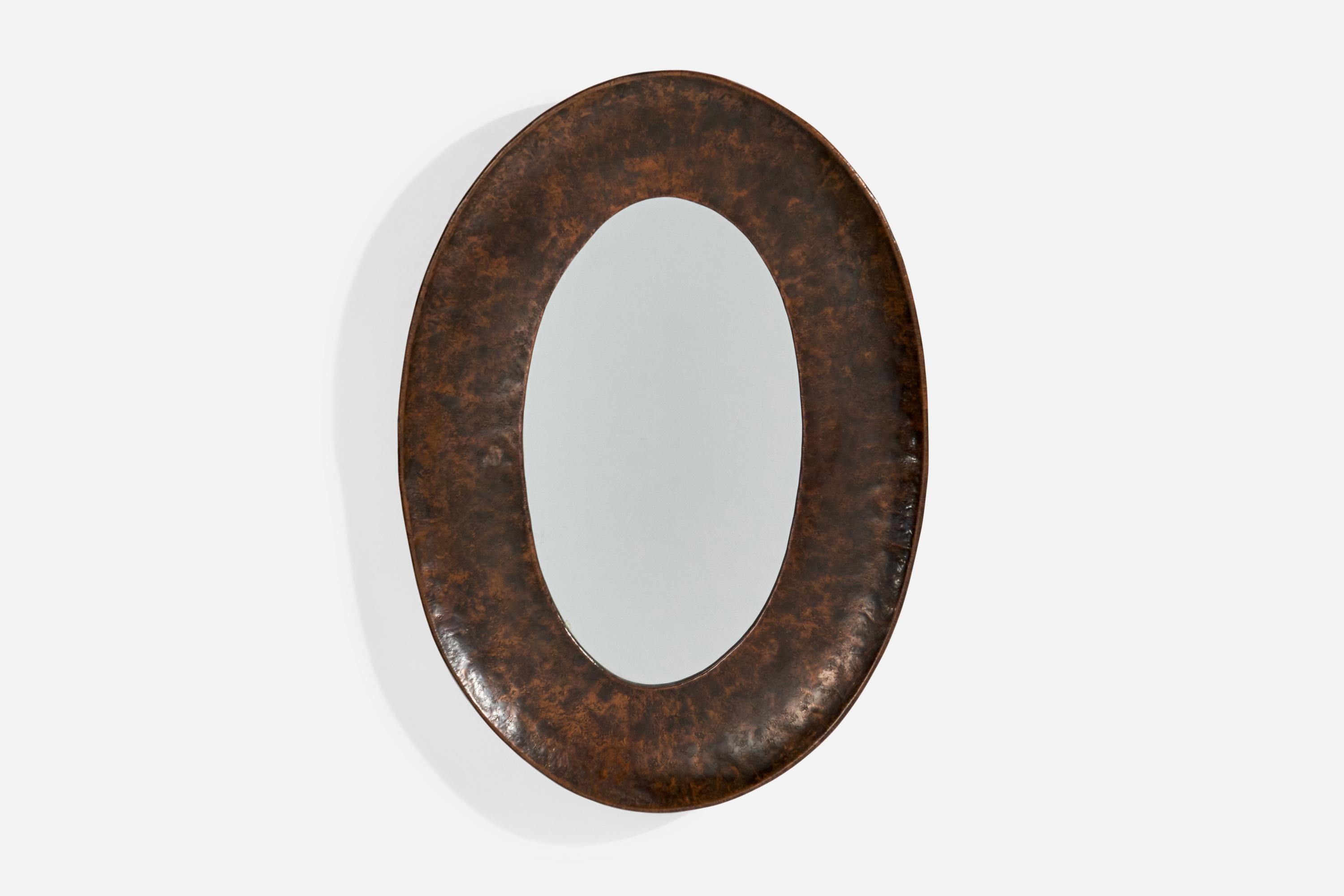 A patinated and hammered copper wall mirror, designed and produced by Angelo Bragalini, Italy, 1960s.