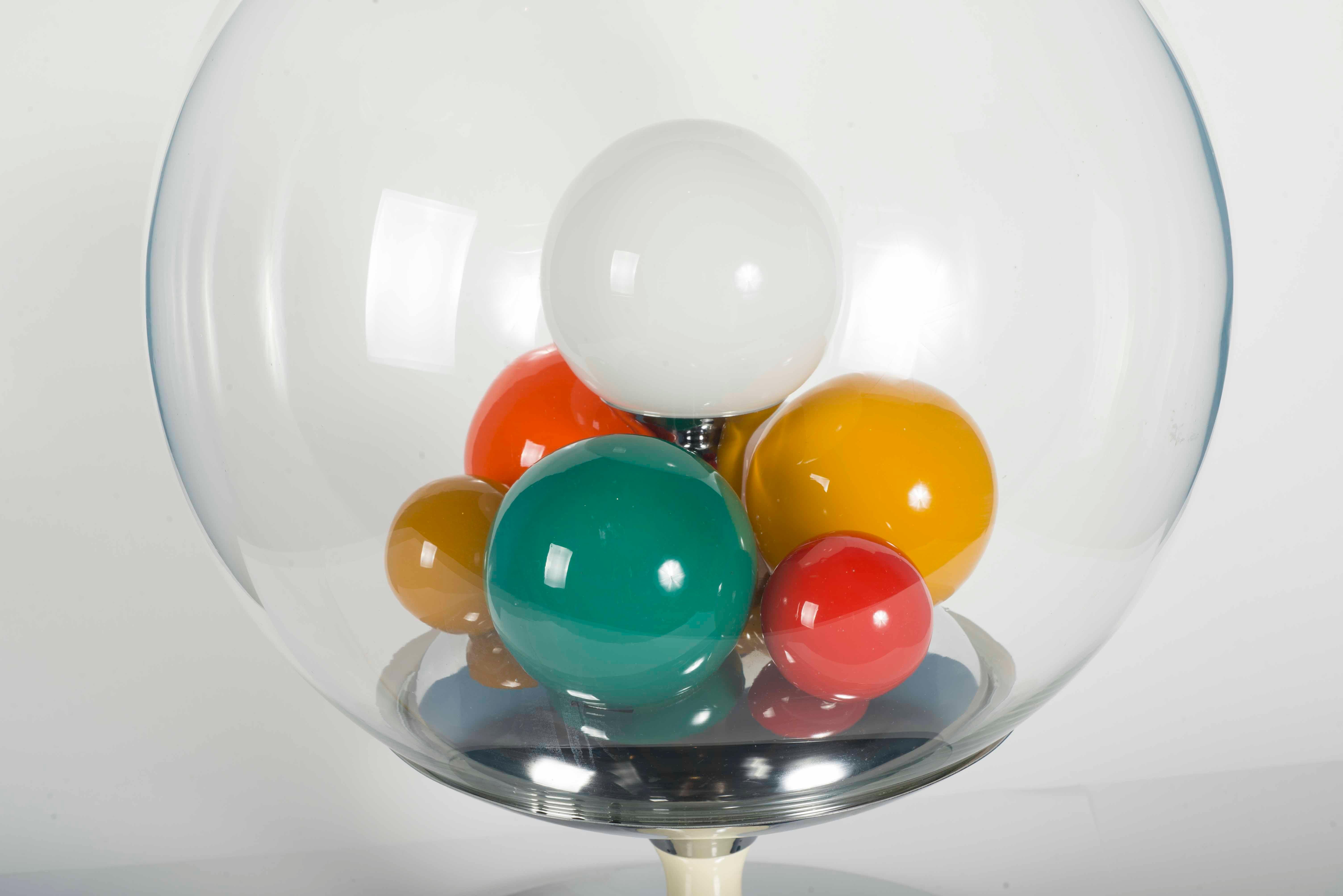 Table lamp designed by Angelo Brotto for Esperia, Italy 1965. This lamp has small glass blown balls of different colors inside that illuminate and give a colorful light. Chromed metal tulip foot, with wooden middle piece and glass bowl.