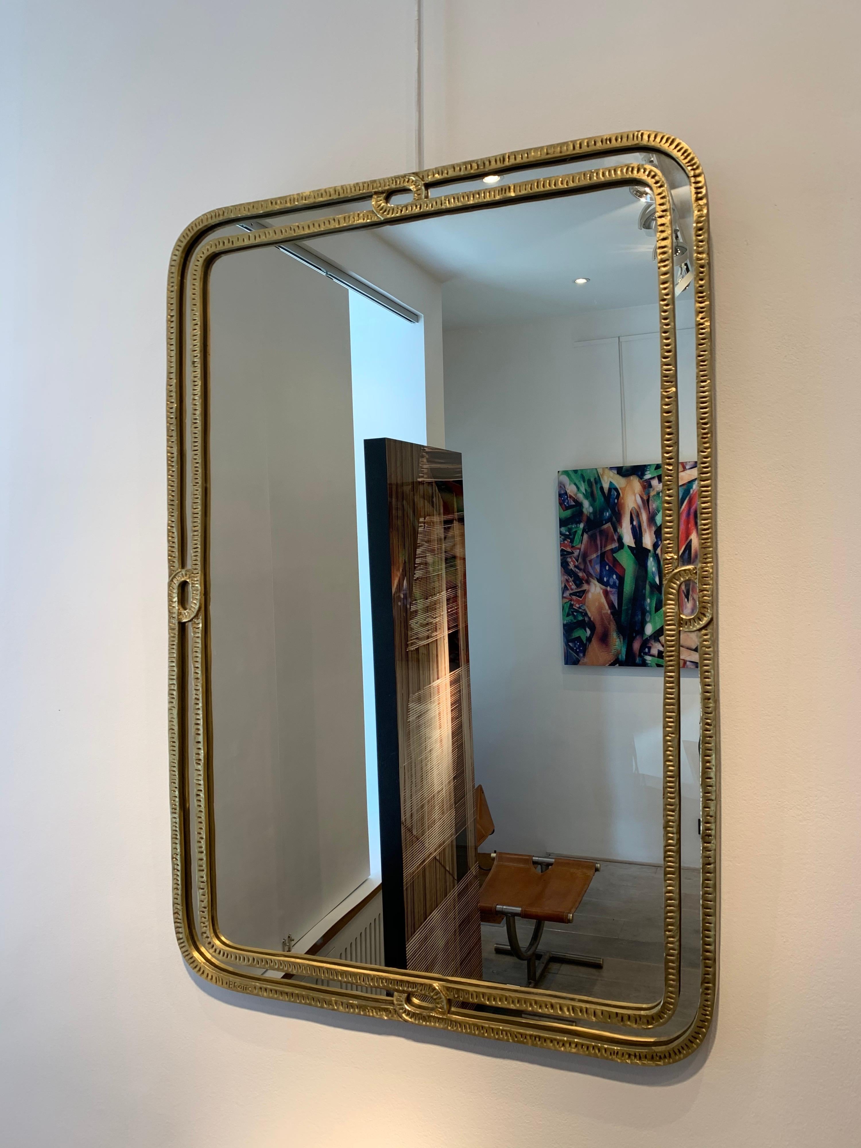 Angelo Brotto is a famous Italian designer, who specialised in lights and wall decoration. This mirror, which signed, is something rare and very elegant in his work.