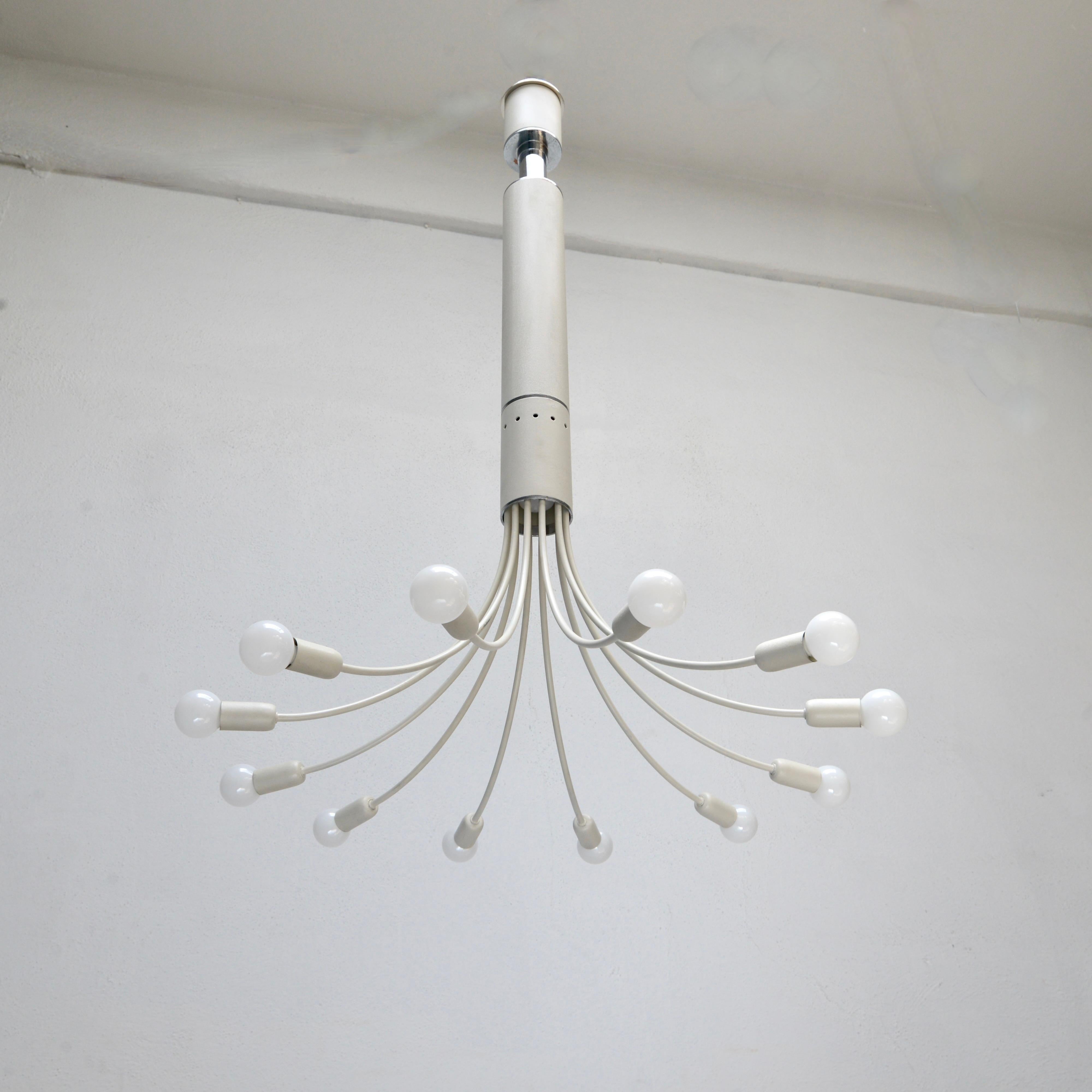 A unique of the period 1970s Angelo Brotto for Esperia chandelier from Italy. Finished in textured painted and plated steel. Partially restored and rewired with 12 E12 candelabra based sockets, and an E26 medium based socket at the center hub, for